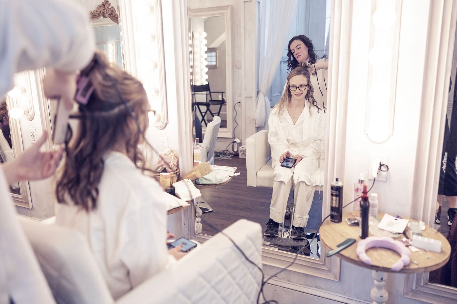 A series of lifestyle photos showing a person in white clothing in various poses around a bright modern interior space.