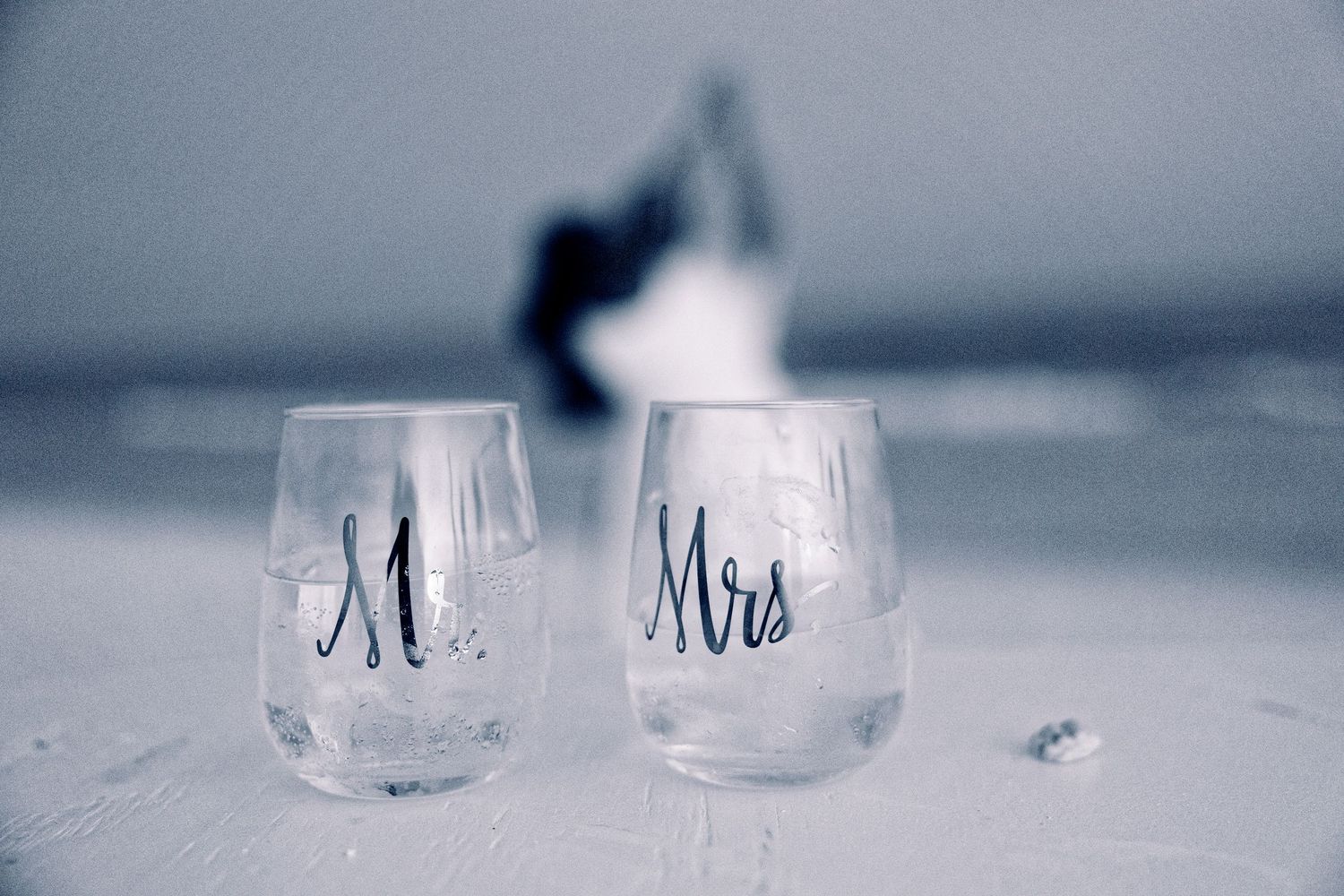 A series of glass candle holders arranged in a row with soft, ethereal lighting effects.