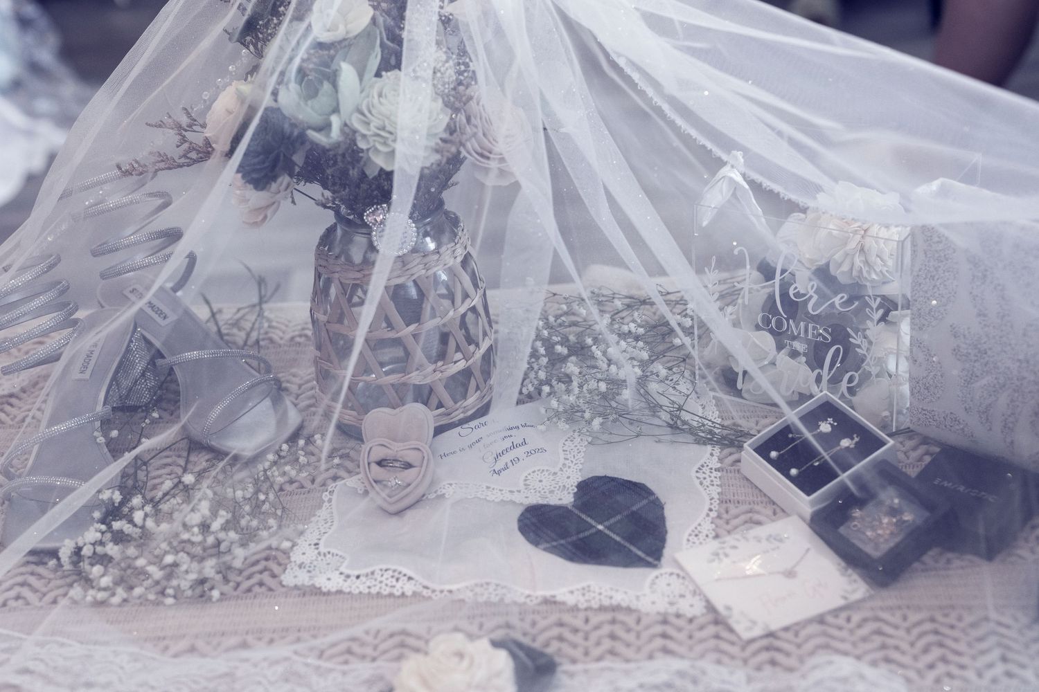 A collection of delicate lace and tulle wedding veils displayed in various lengths and styles.