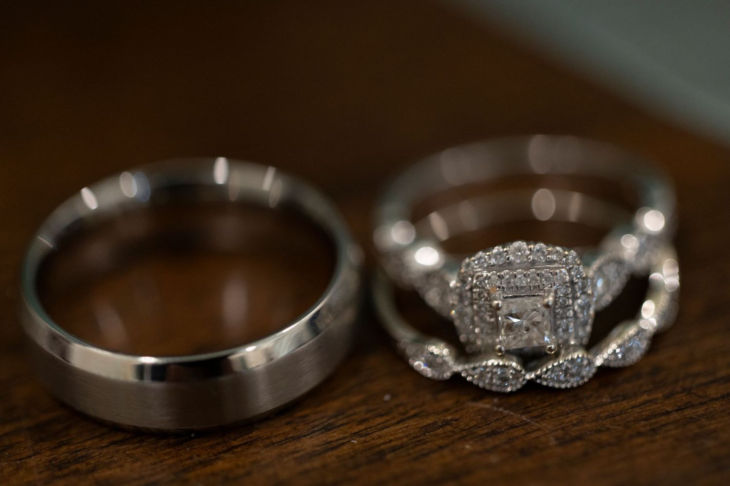 Wedding rings and engagement rings displayed in a series of close-up detail shots on a wooden surface.