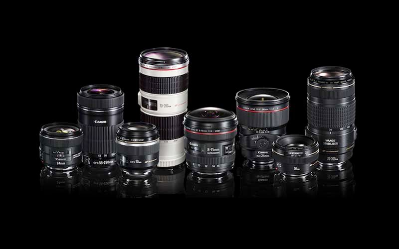 Professional Canon L-series camera lenses displayed on black background.