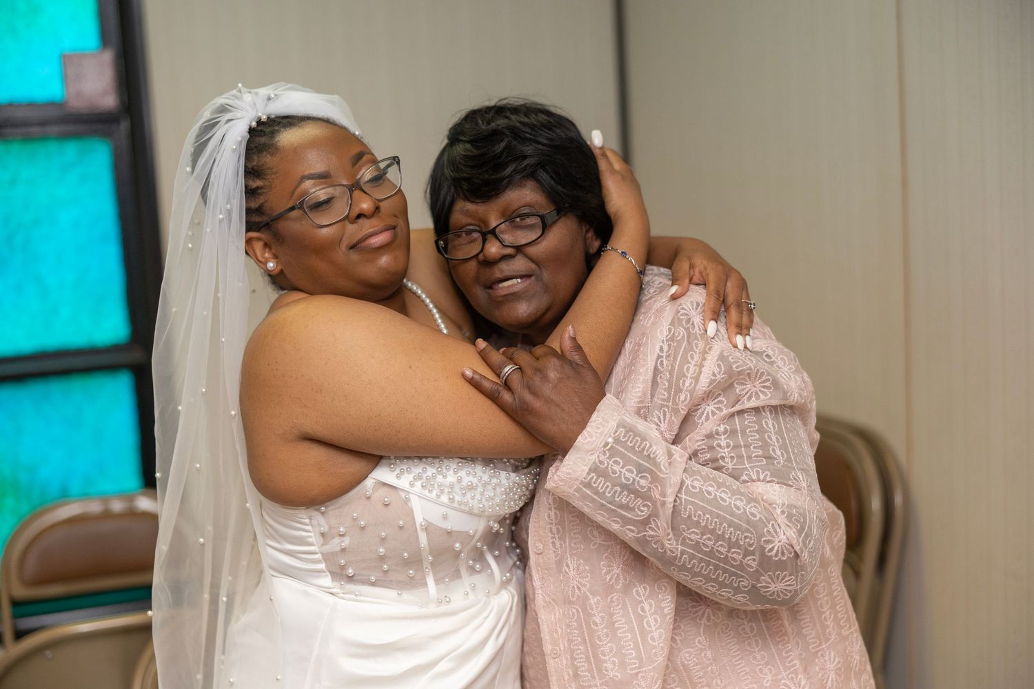 A series of five similar photos showing two people embracing in an indoor setting with teal colored walls.