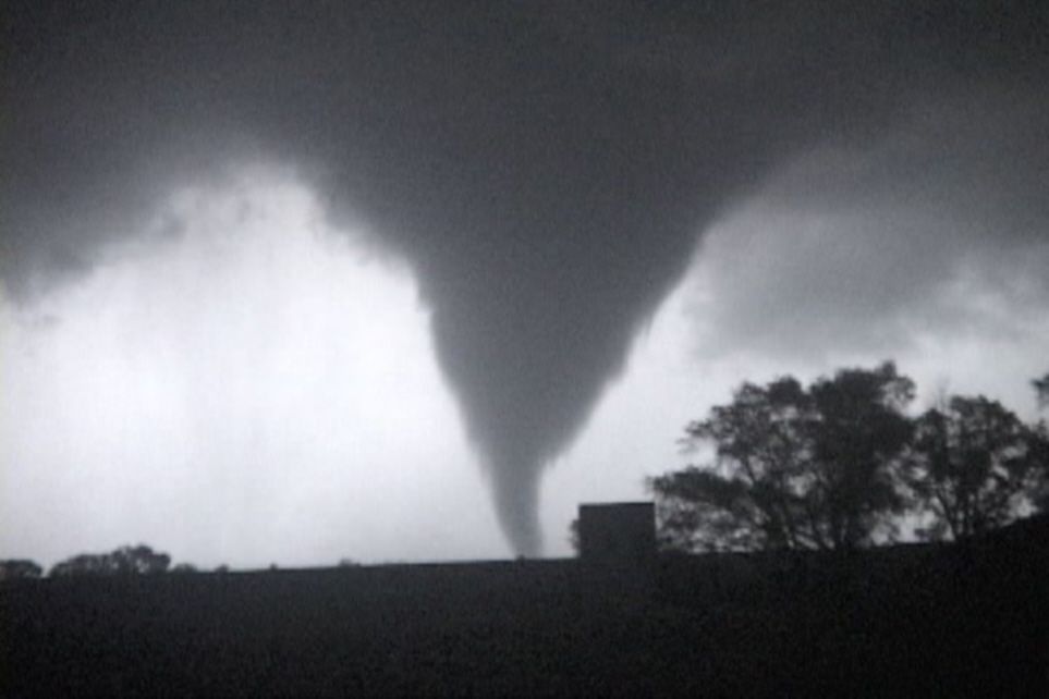A dramatic series of black and white photographs showing a powerful tornado funnel cloud forming against a stormy sky.