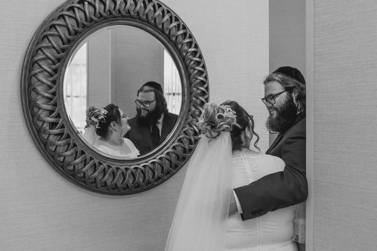 Black and white photo series showing decorative round mirrors on a wall with figures reflected in them.