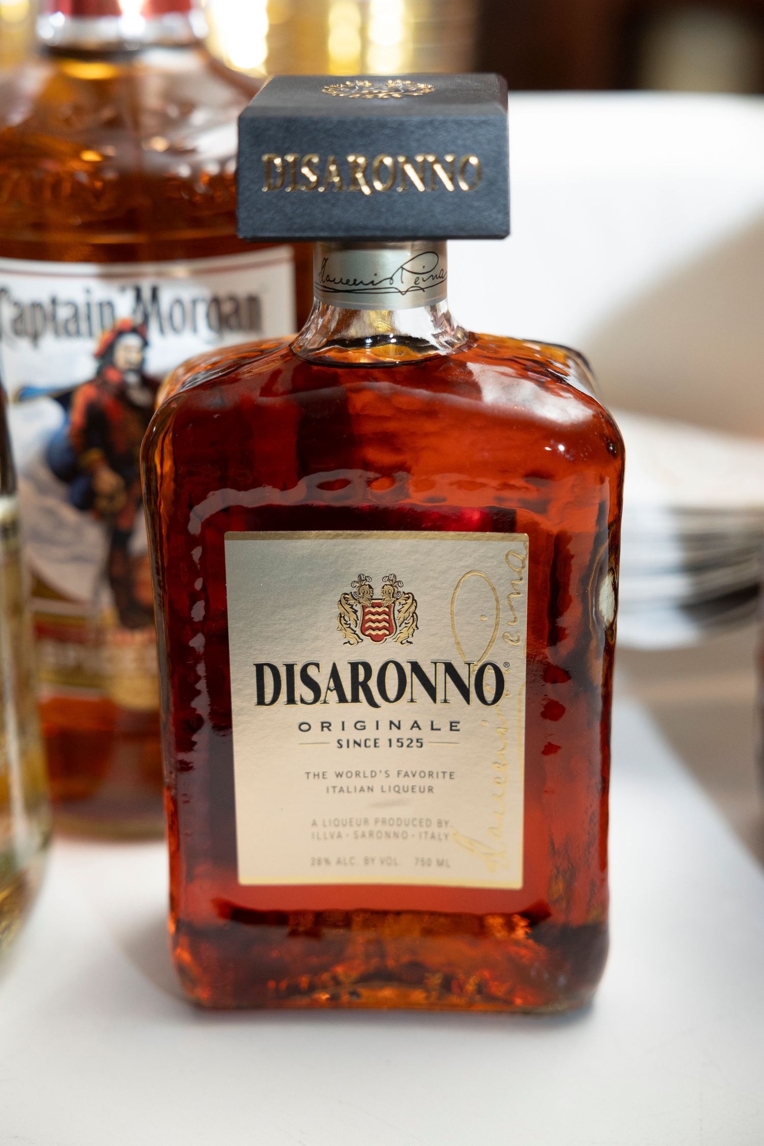 Bottle of Disaronno Originale liqueur displayed on white tablecloth.