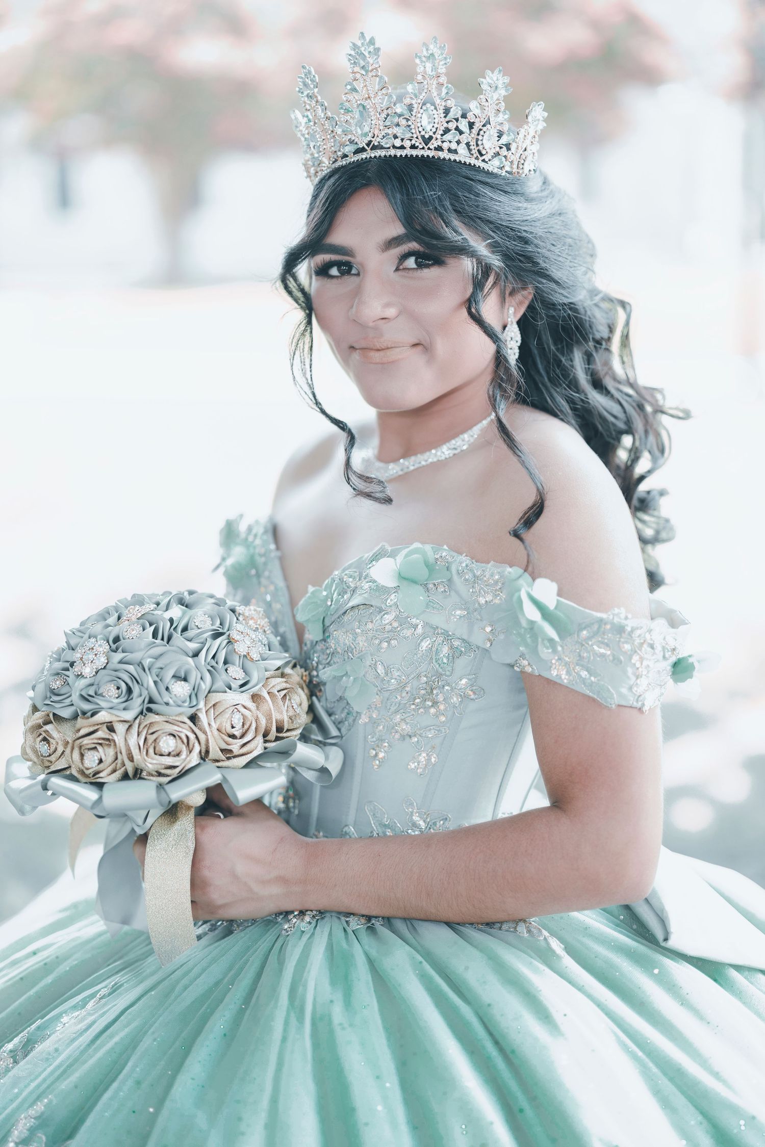 Elegant mint green quinceañera ball gown with intricate beading and off-shoulder design showcased in a dreamy photoshoot.