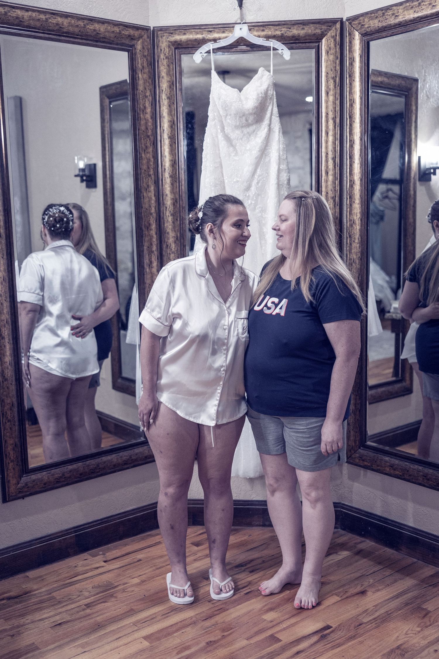 A series of five mirrored reflections showing people standing in casual attire on hardwood flooring.