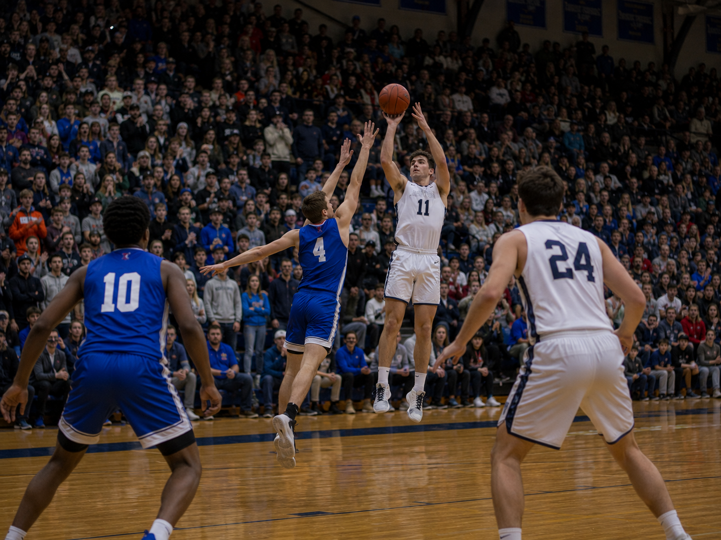 Player #11 in white shoots a jump shot over defender #4 in a crowded college basketball game.