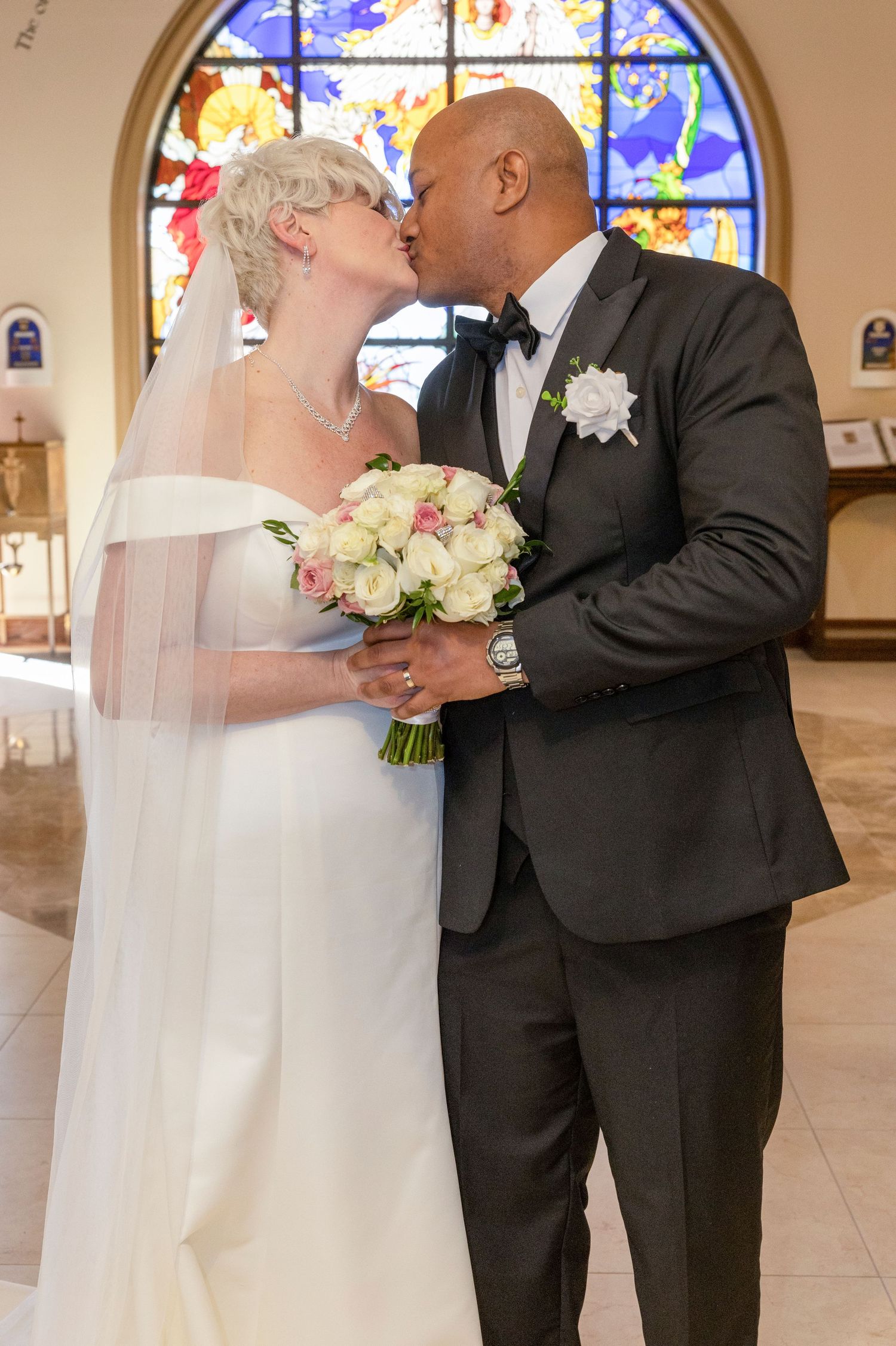 Three wedding photos show a couple in traditional white dress and black suit sharing their first kiss in a church setting.