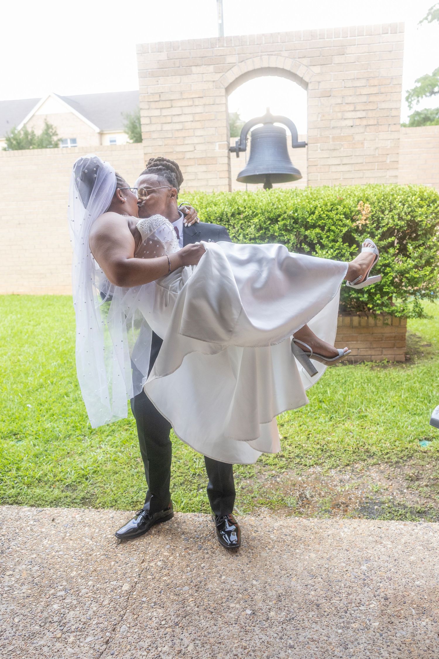A romantic wedding moment captured in sequence showing a couple performing a dip pose outside a brick building.