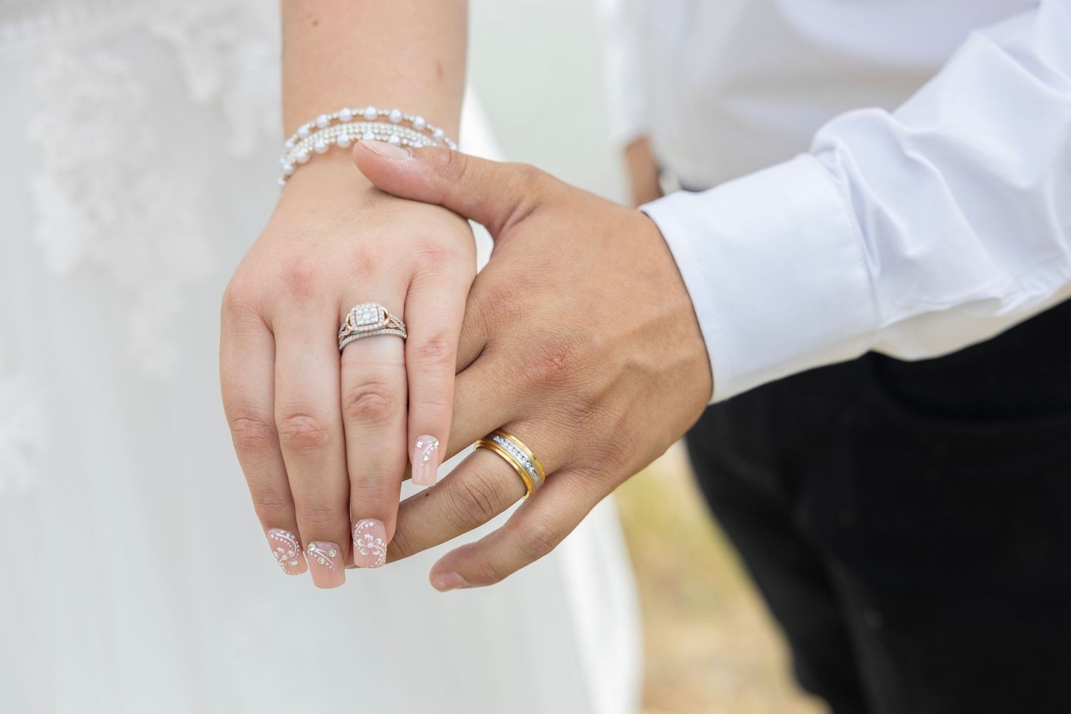 Close-up photos of hands wearing wedding rings and engagement rings showing various styles and poses.