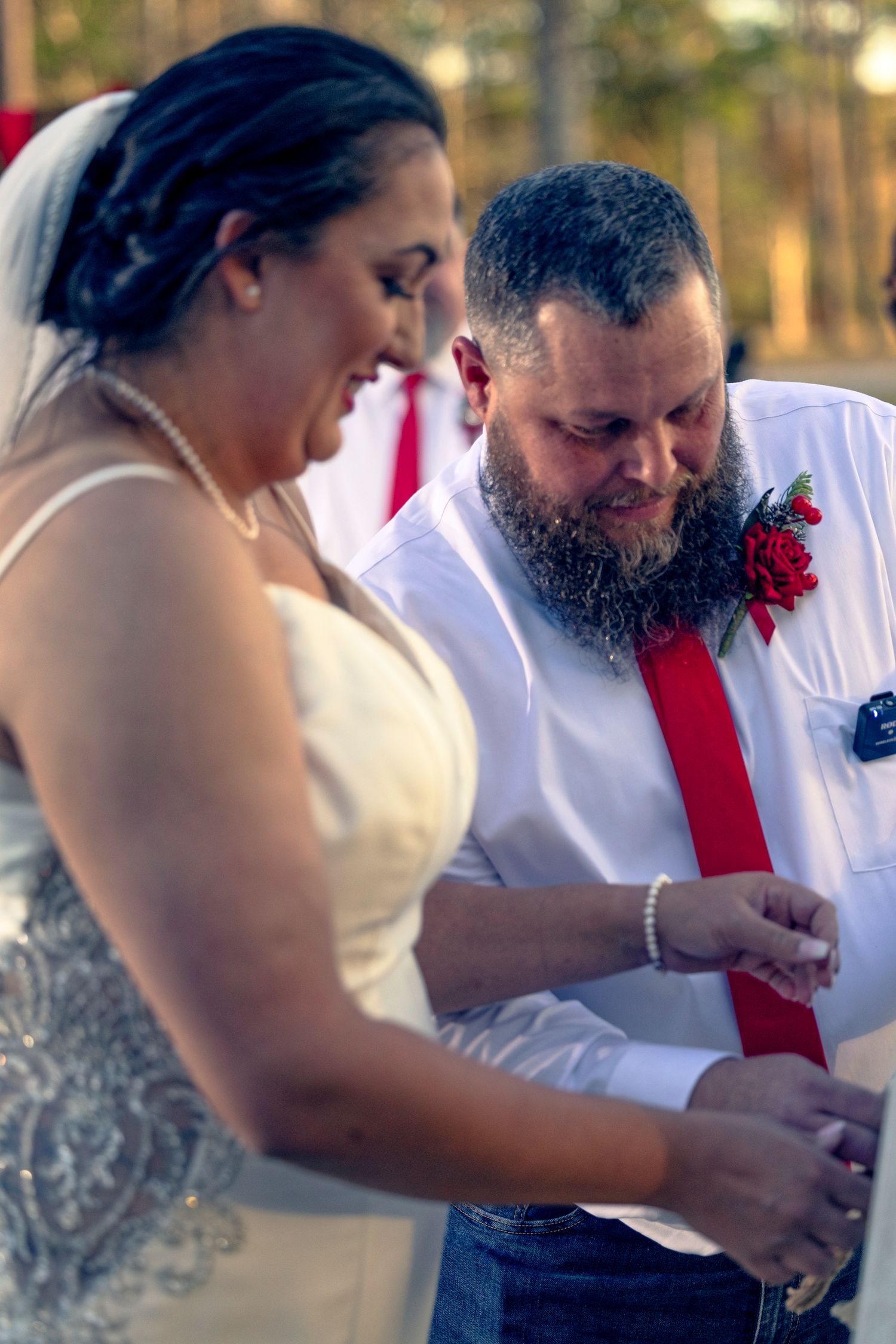 A sequence of wedding photos shows a couple signing their marriage documents together at an outdoor ceremony.