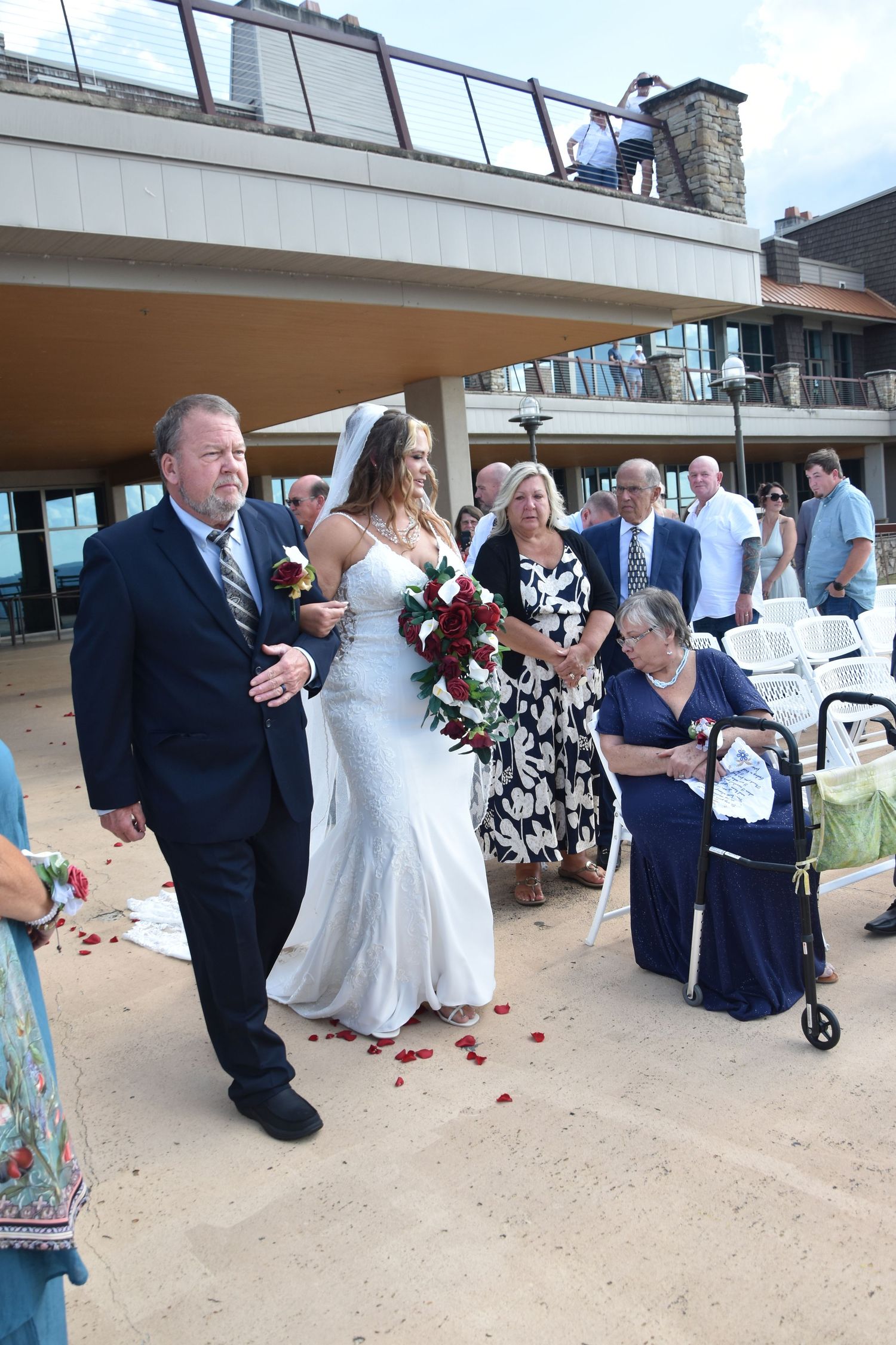 A sequence of proposal photos showing a couple getting engaged on a beach boardwalk with onlookers present.