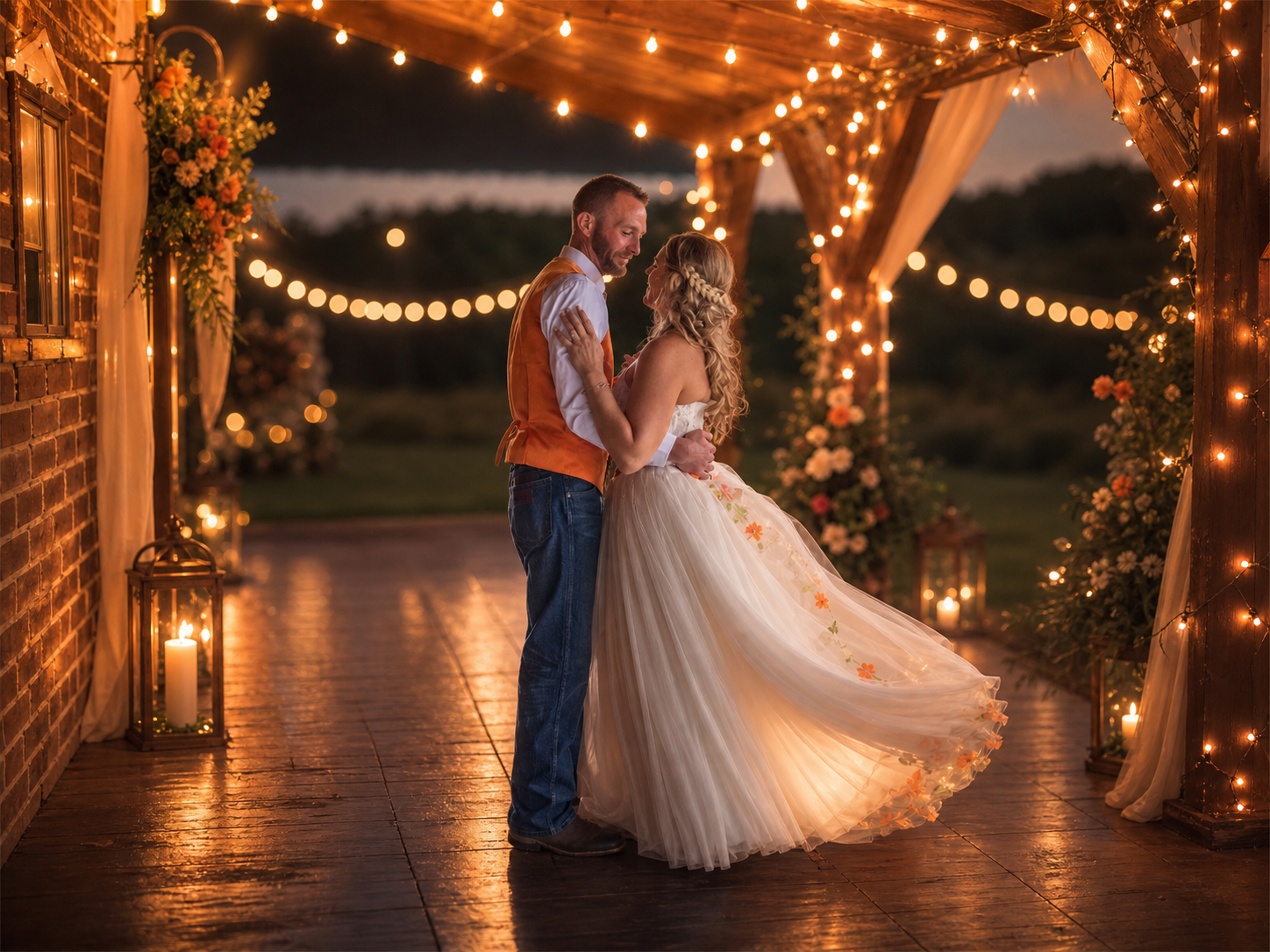 Couple dancing under string lights at romantic outdoor wedding venue with warm golden glow and floral decor at dusk.