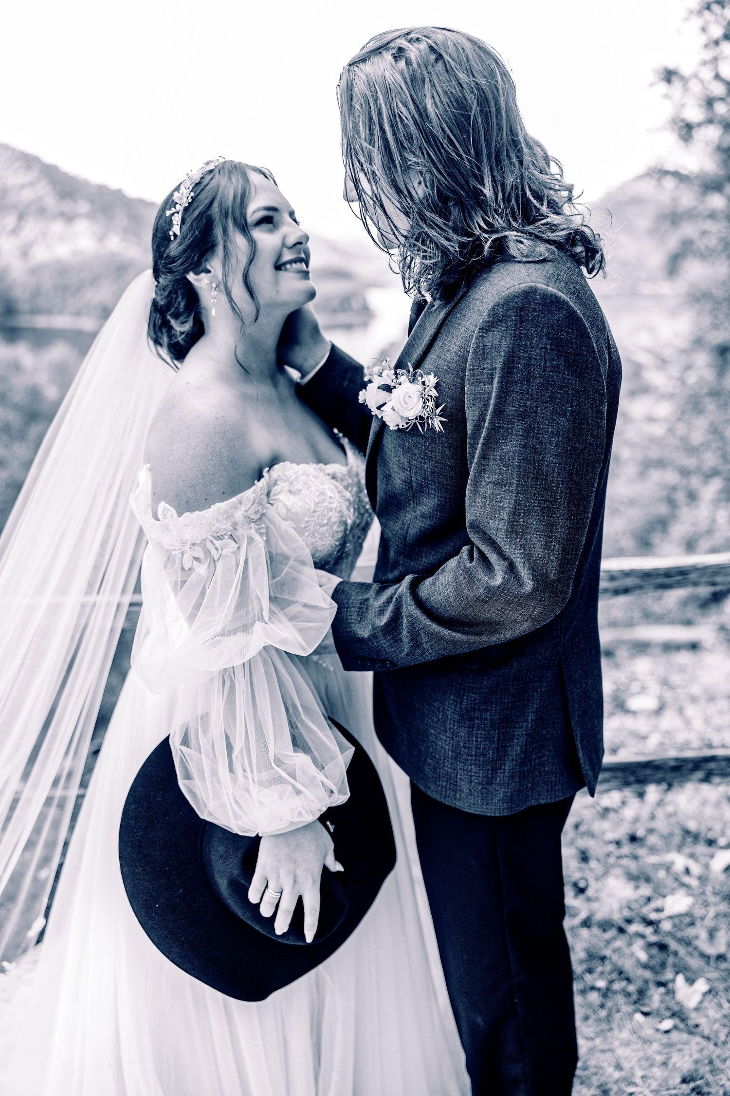 A romantic black and white photo series showing a couple embracing outdoors in wedding attire.