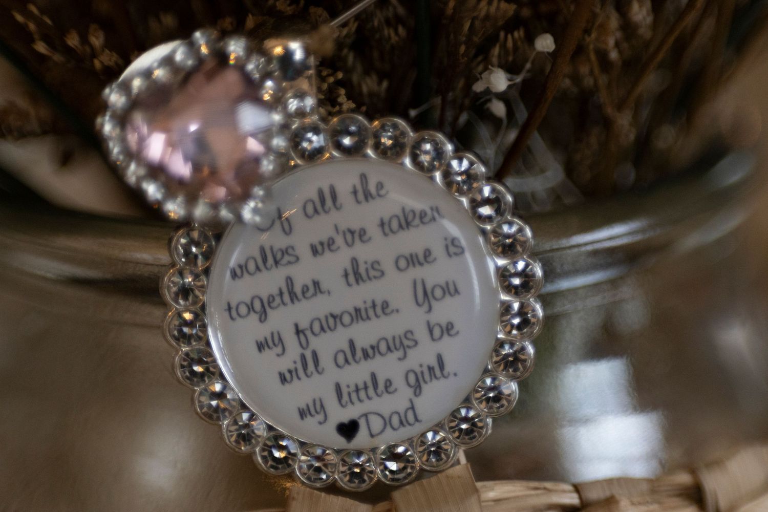 Close-up shots of delicate silver charm bracelets with engraved messages displayed on a reflective surface.