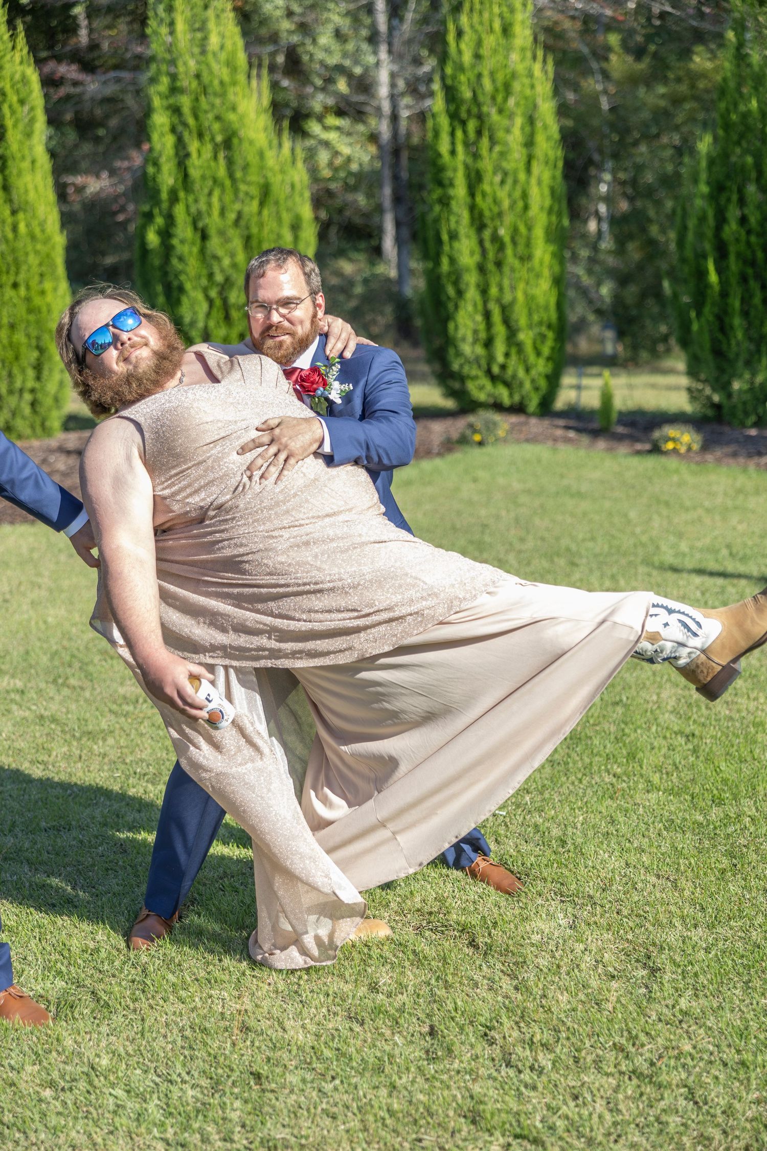 A sequence of photos showing someone falling dramatically onto a grassy lawn with tall cypress trees in the background.