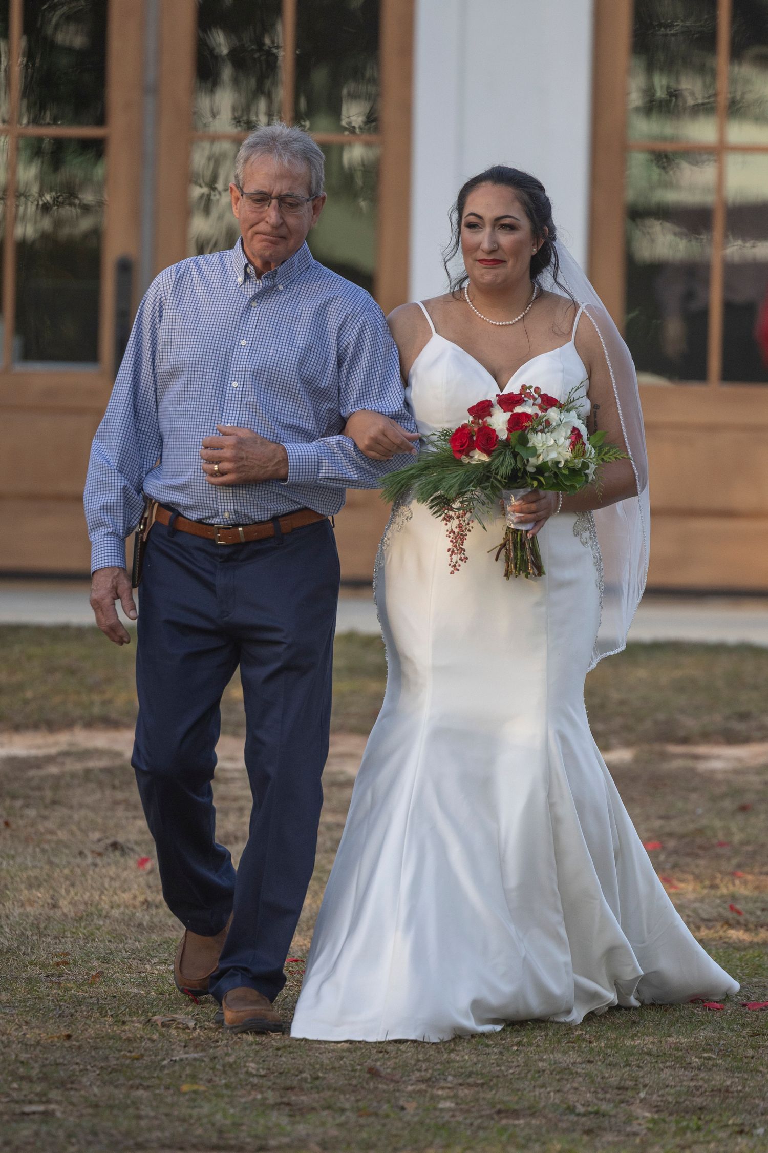 A wedding sequence showing a couple walking together outdoors, with the bride in a white dress and groom in blue attire.