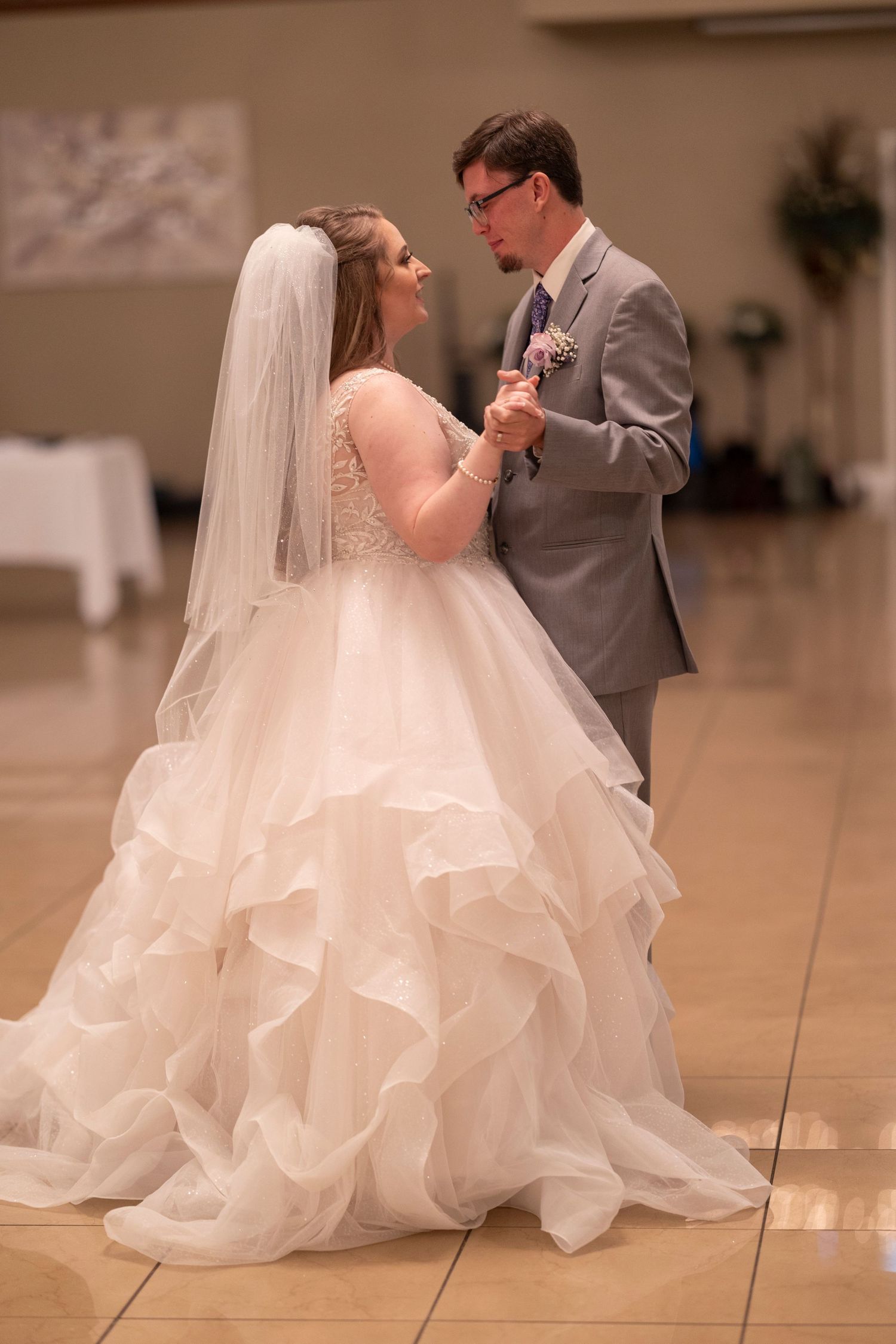 A couple shares a romantic moment during their first dance at their wedding reception.