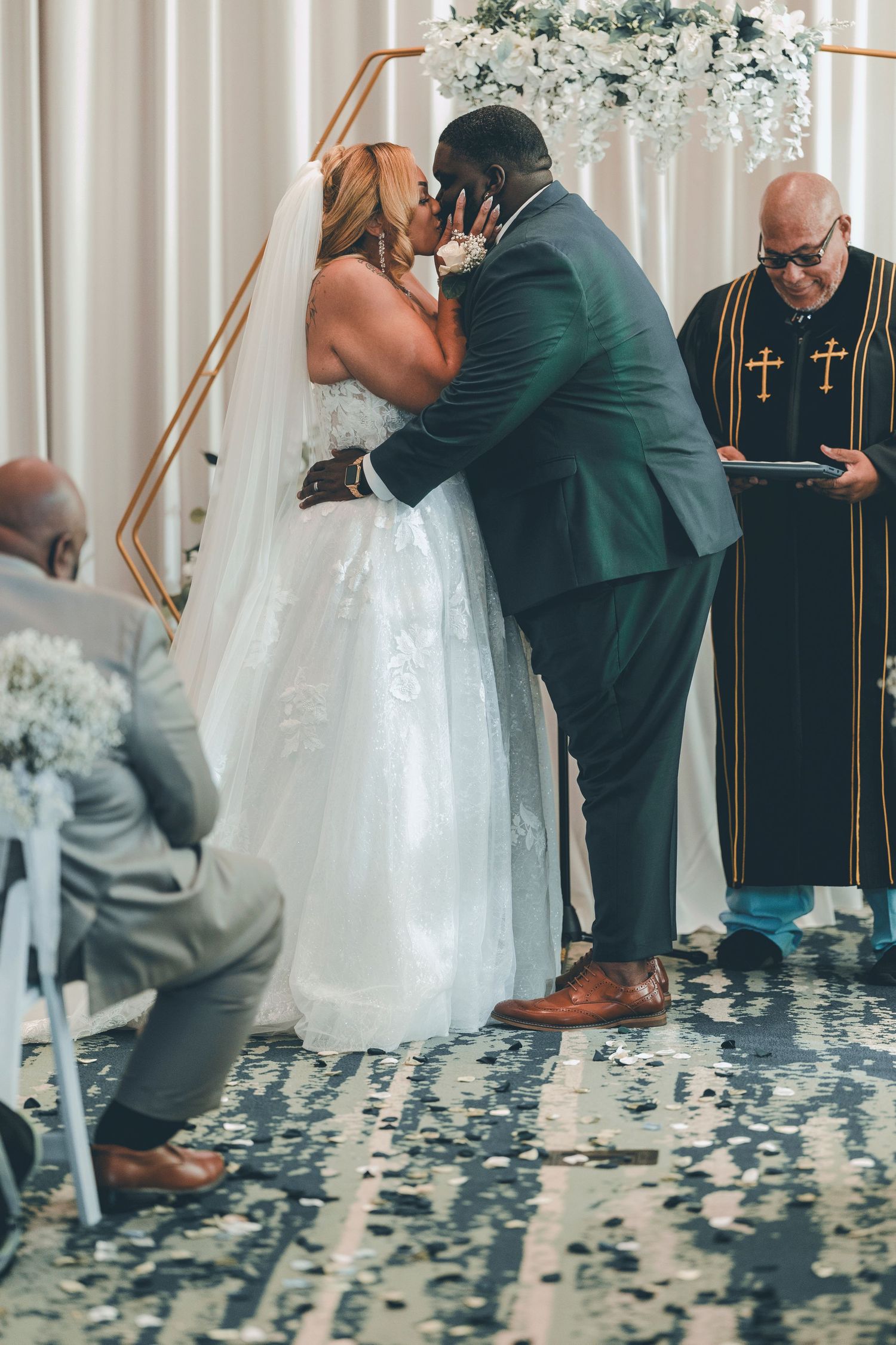 A sequence of wedding ceremony photos showing a couple kneeling at an altar decorated with white floral arrangements.