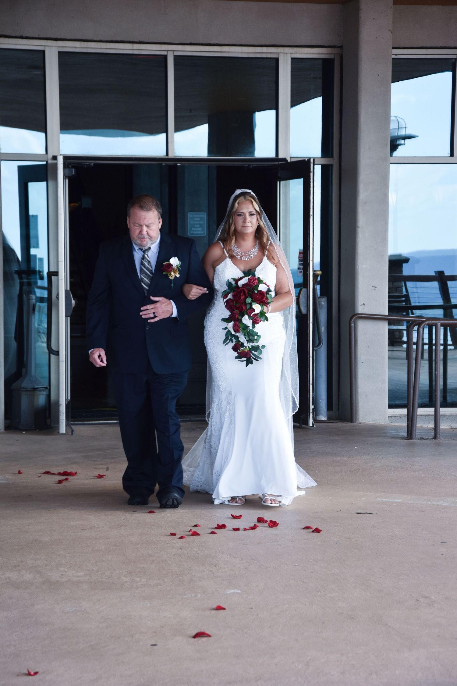 A series of wedding photos showing a couple walking through a covered patio area with scattered rose petals on the ground.