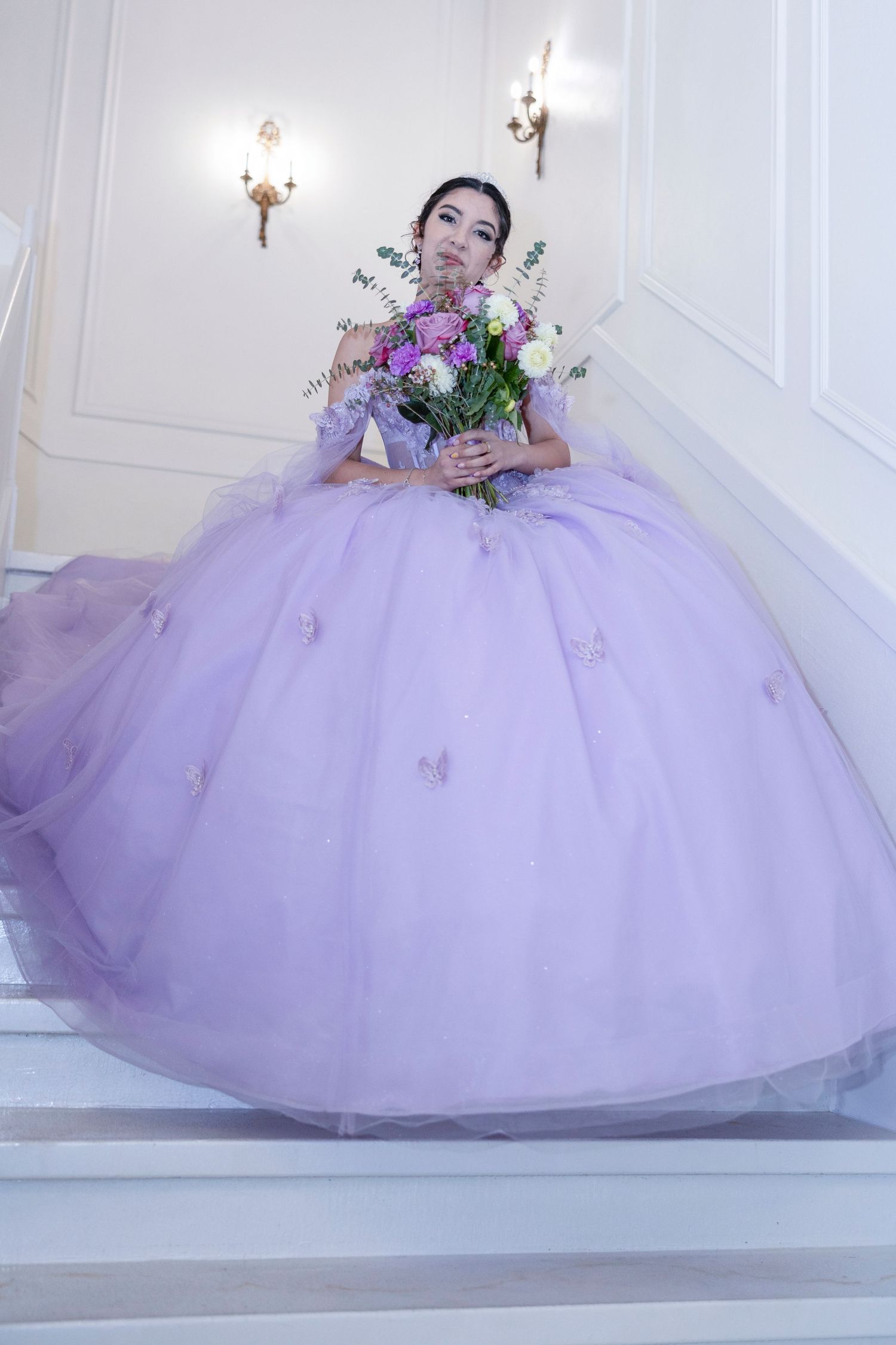 A stunning lavender ball gown with tulle skirt fills the frame in an elegant bridal photoshoot series.