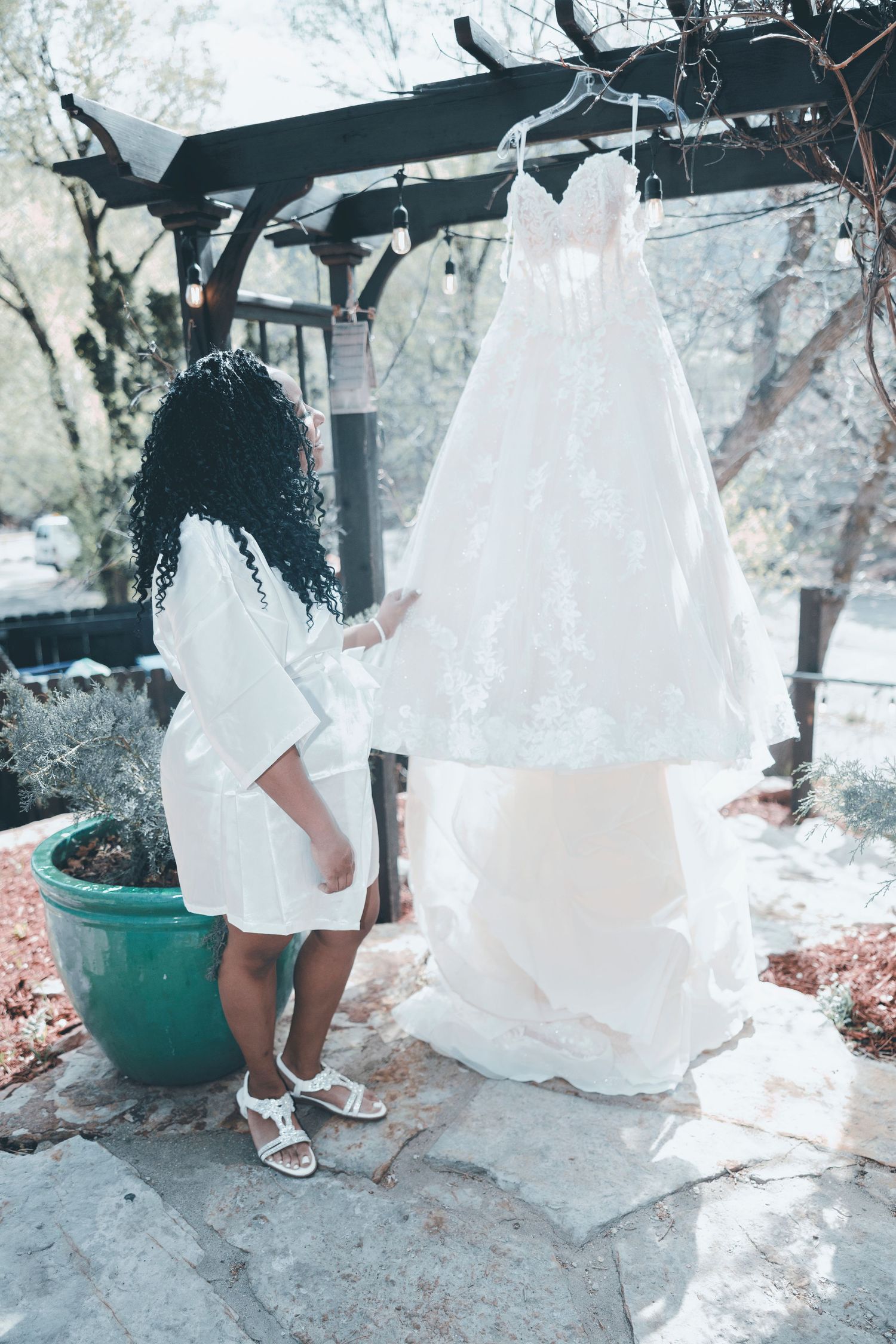 A series of ethereal white wedding dress photos in a snowy outdoor setting with teal planters and natural elements.