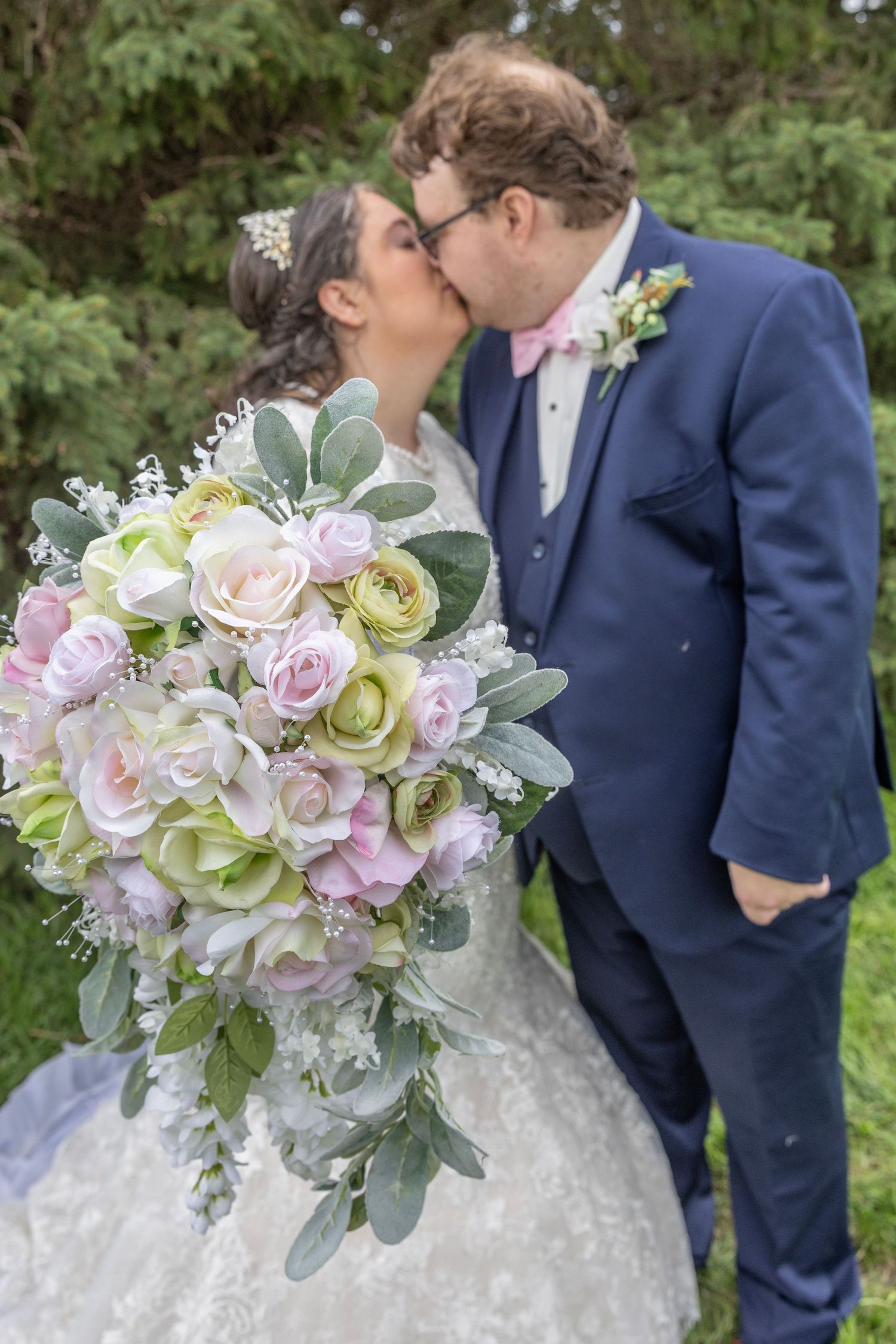 A romantic wedding photo series featuring a white and pink bouquet with roses, eucalyptus and soft pastel florals.
