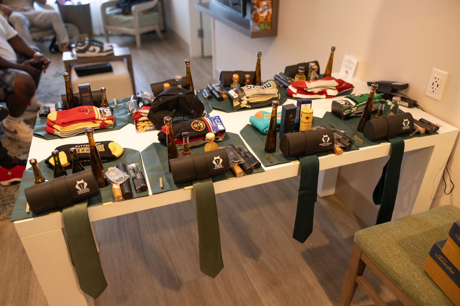 A row of olive green Christmas stockings hang from a wooden mantel decorated for the holiday season.
