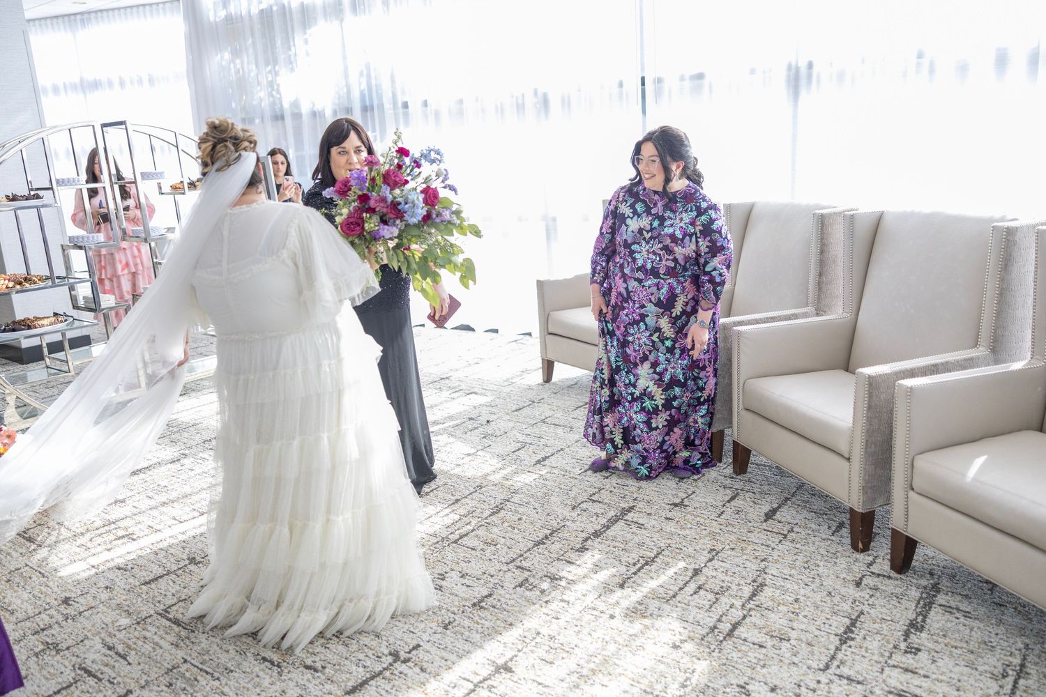 A sequence of wedding dress preparation photos showing the gown being adjusted and styled in an elegant white room.