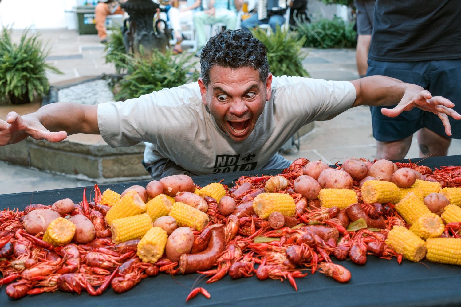 Colorful display of crawfish and citrus fruits arranged on a dark table.