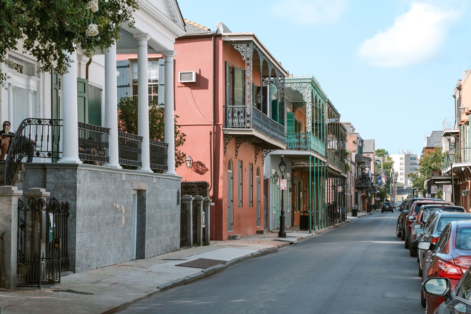 Historic street view of colorful buildings and architecture in New Orleans' French Quarter.