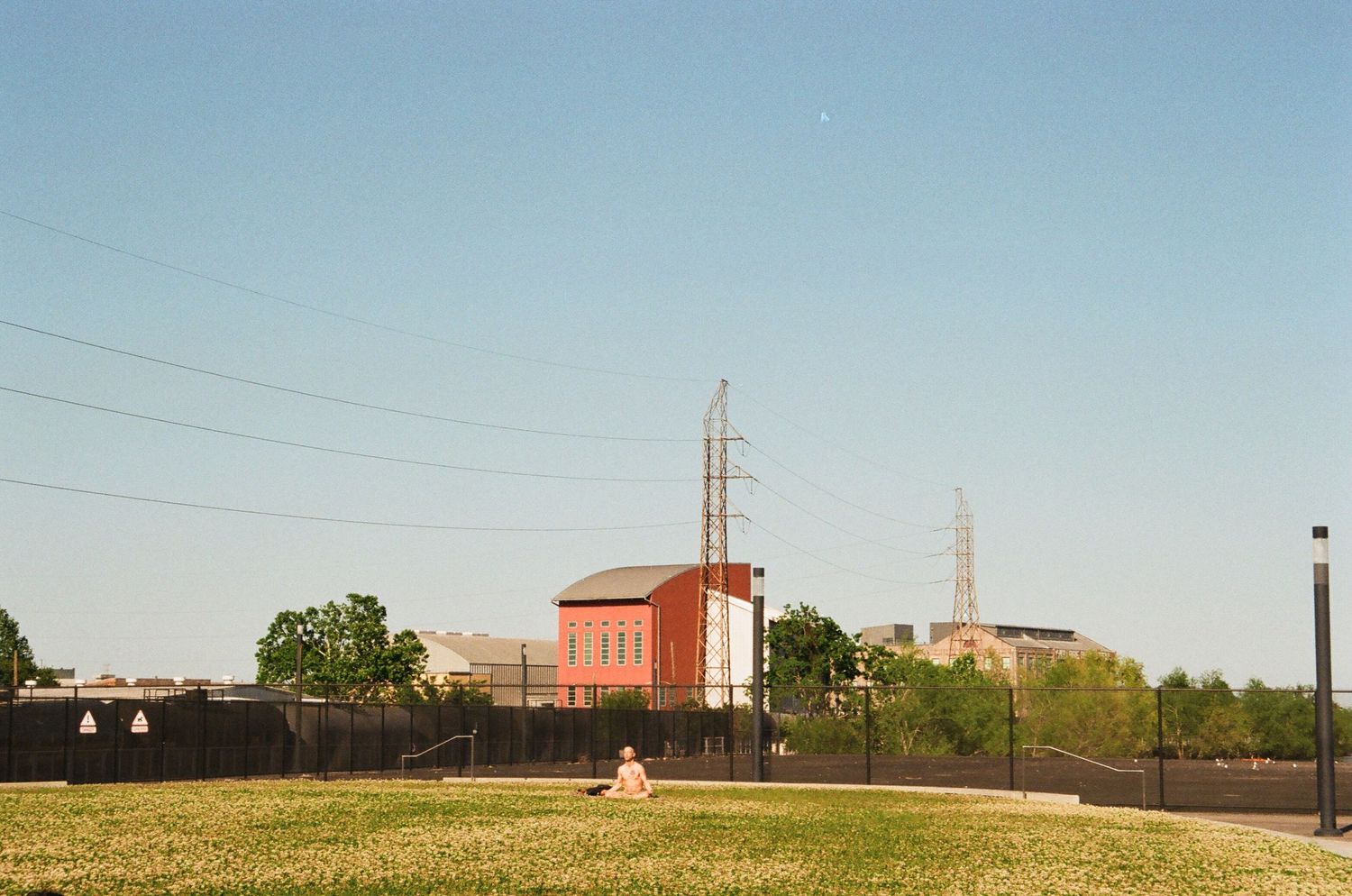 Industrial buildings and power lines stretch across a rural landscape.