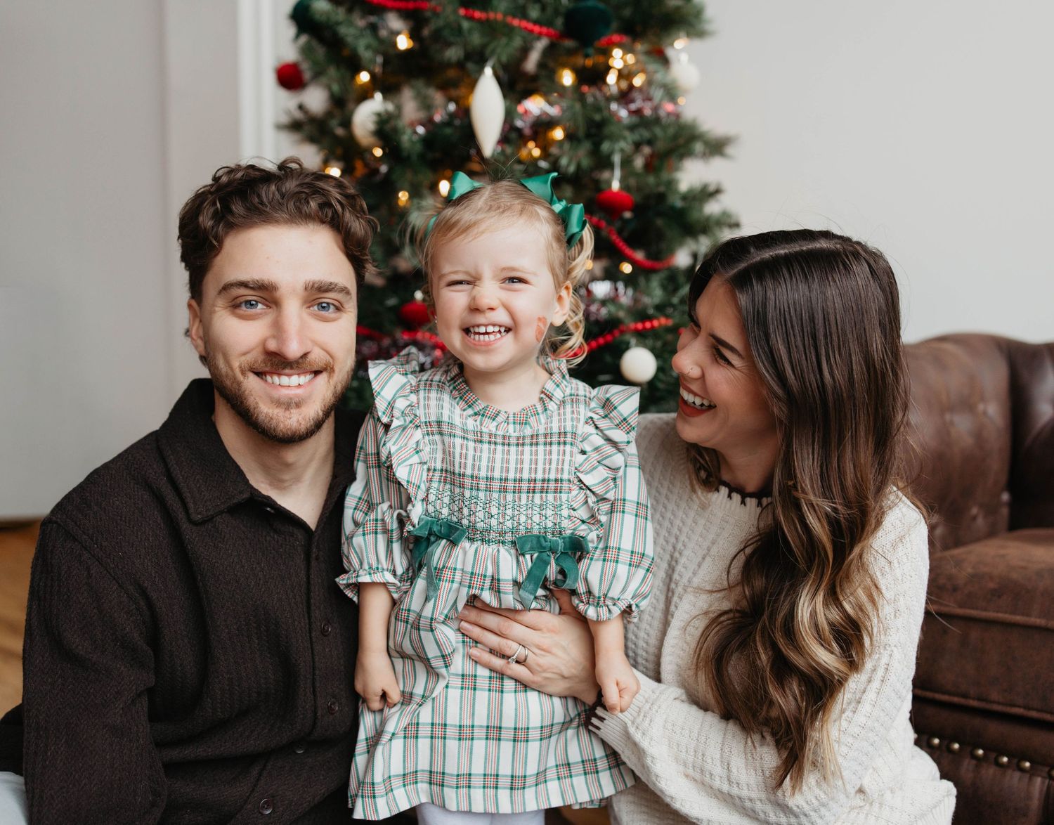 A series of five holiday family photos showing joyful moments around a decorated Christmas tree.