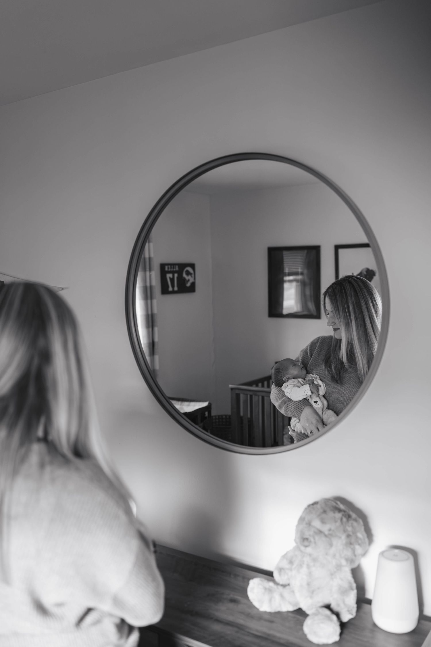 A series of black and white mirror reflections showing movement and stuffed animals in a minimalist interior setting.
