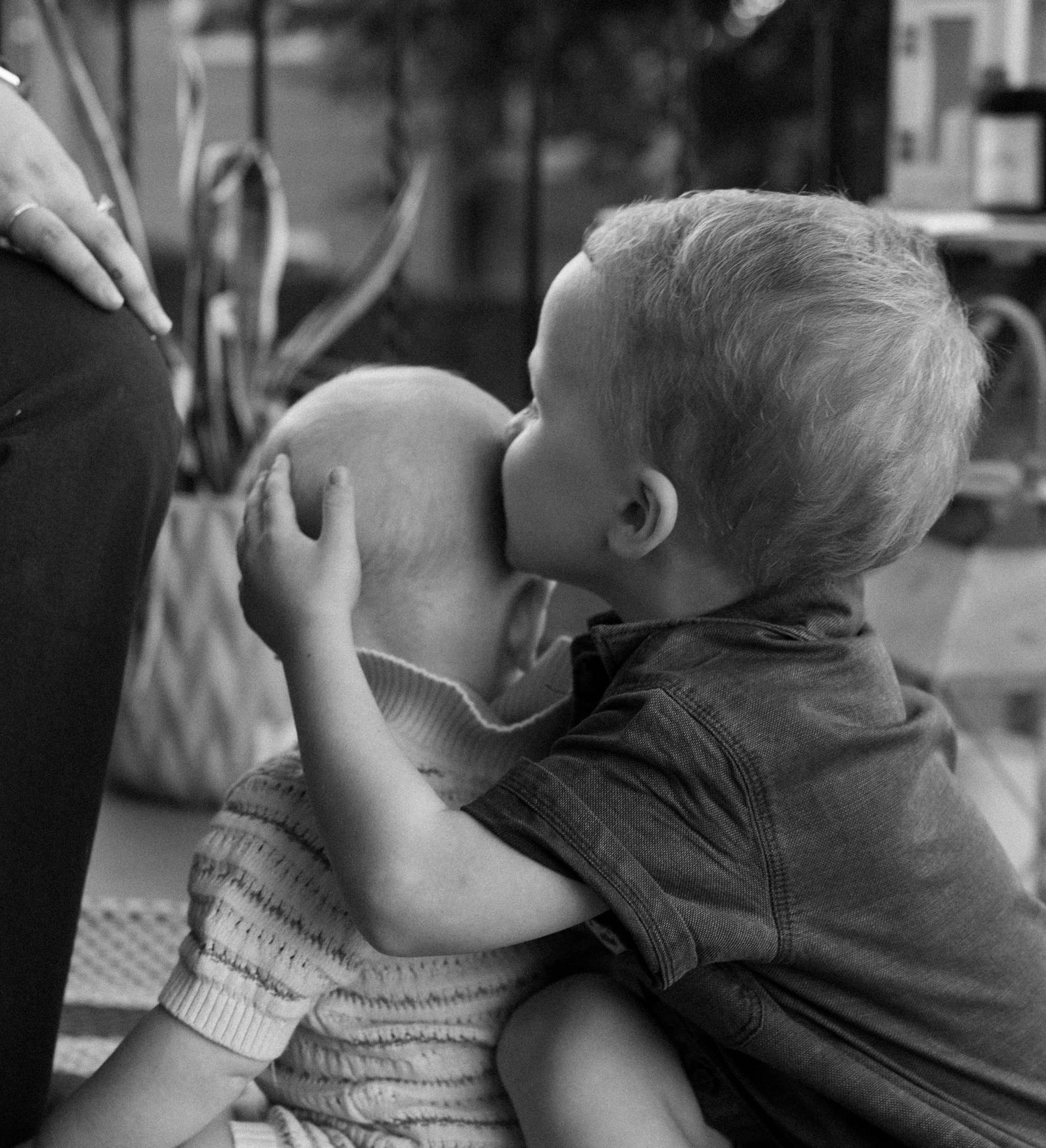 A black and white photo series showing a child drinking from a glass in progressive stages.
