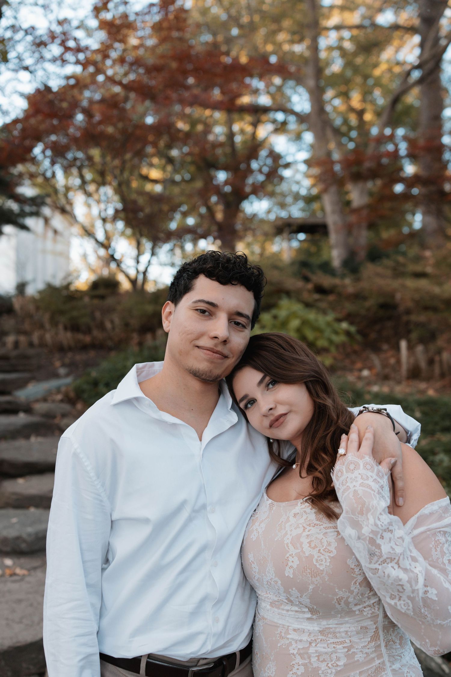 A romantic outdoor photo session featuring a couple in white attire during autumn.