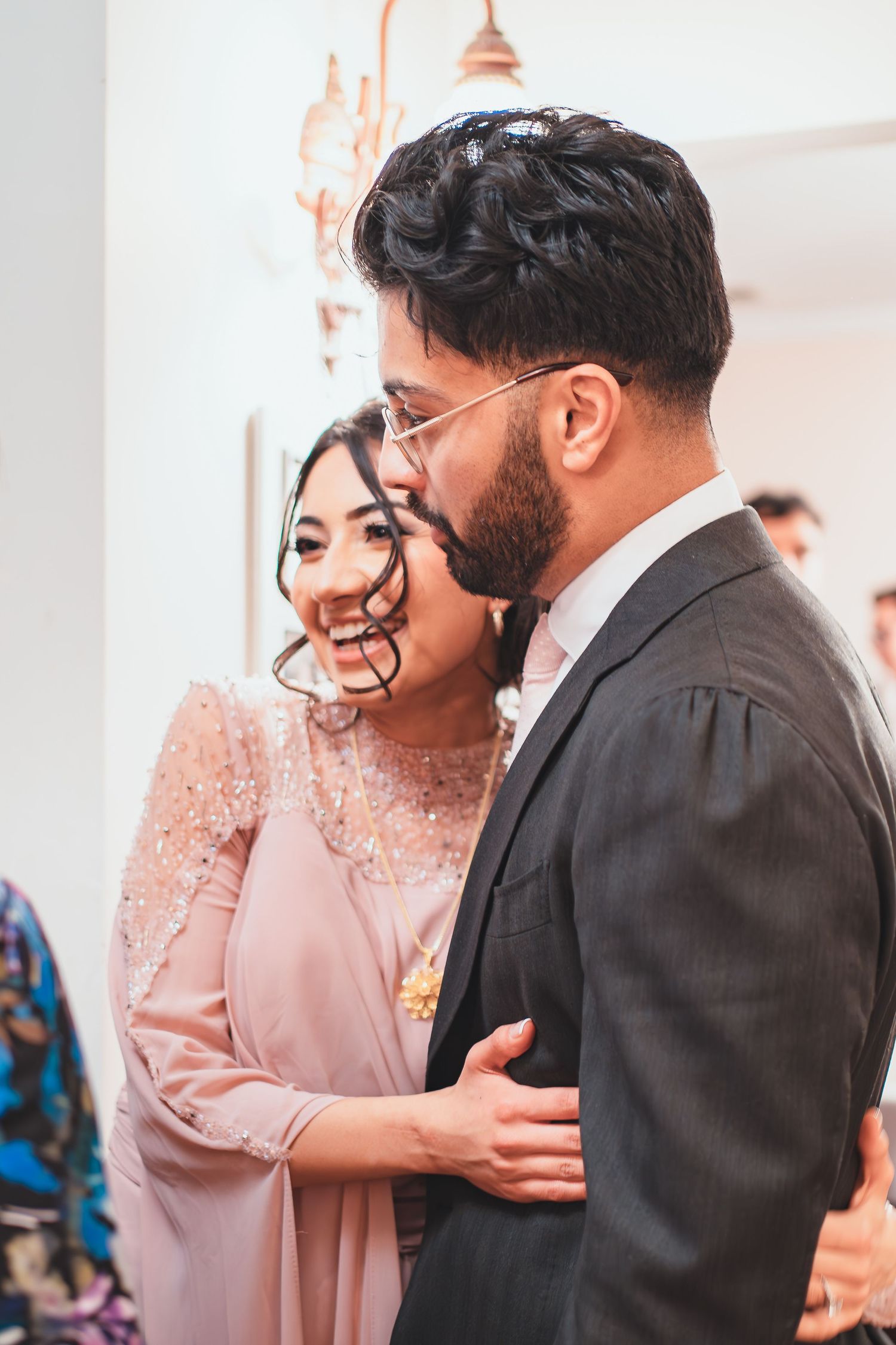 A couple in formal attire shares an intimate moment during their celebration.