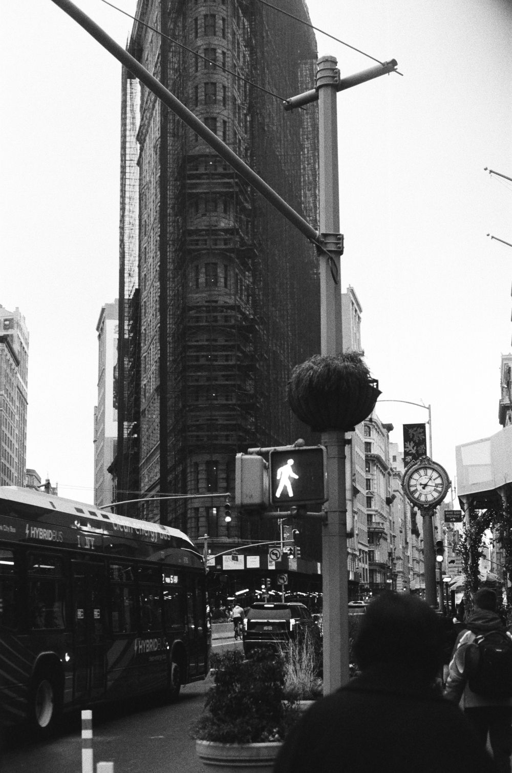 Urban street scene with dramatic black and white architecture and fire escapes.