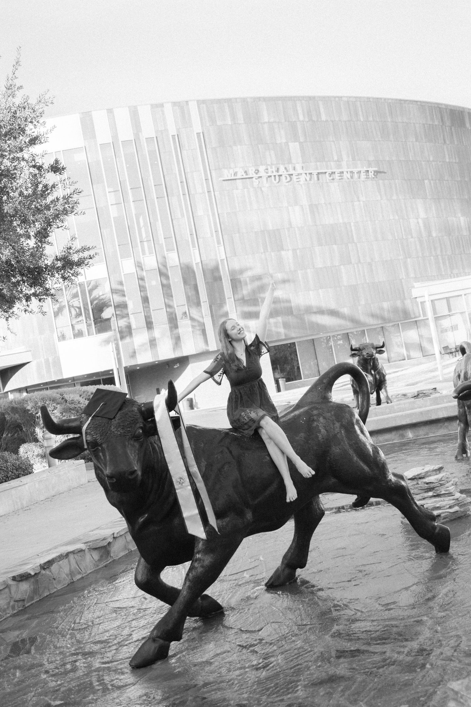 A sequence of black and white photos showing a person falling and tumbling on an icy surface near a modern building.