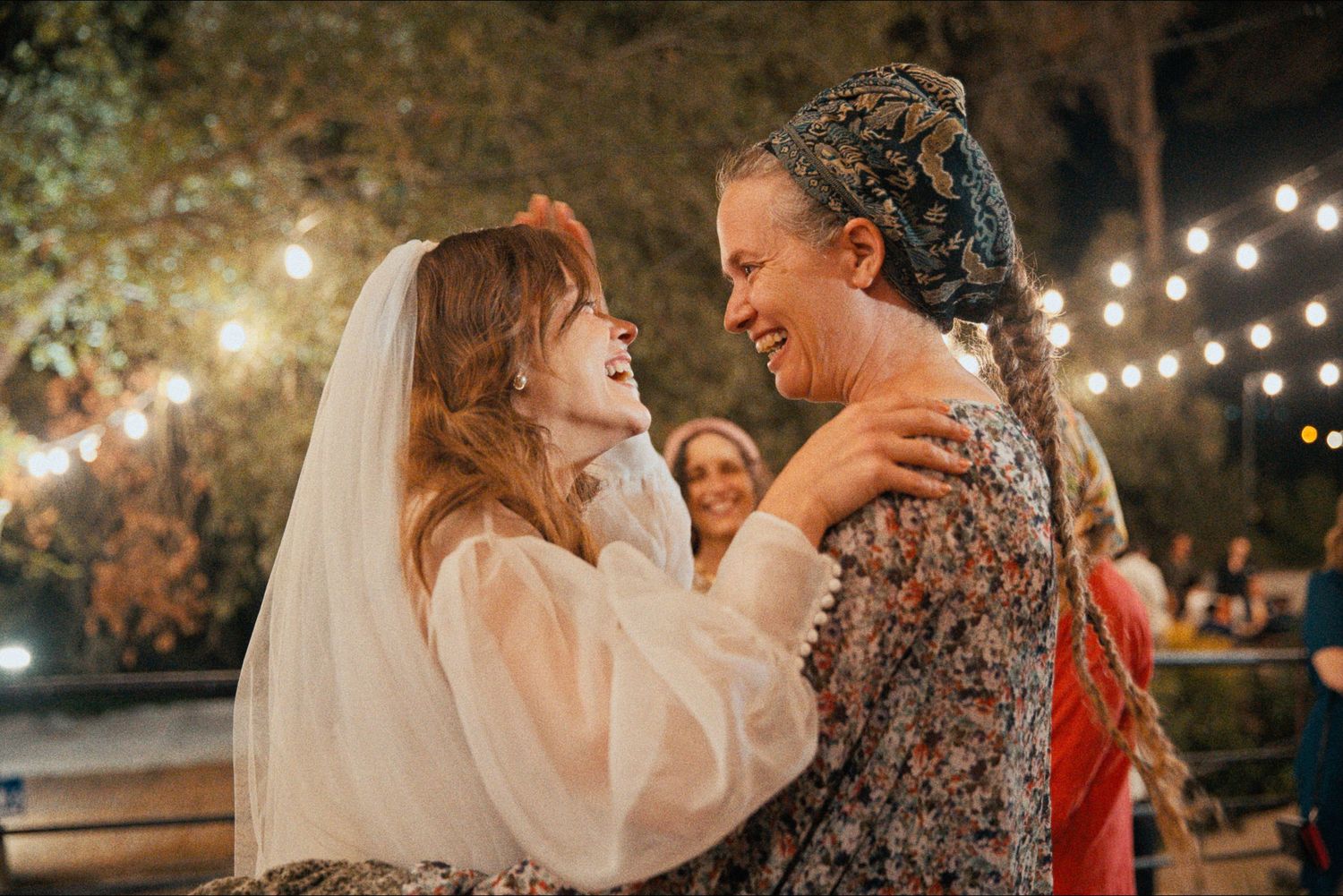 Intimate dance moments captured under outdoor string lights at dusk.