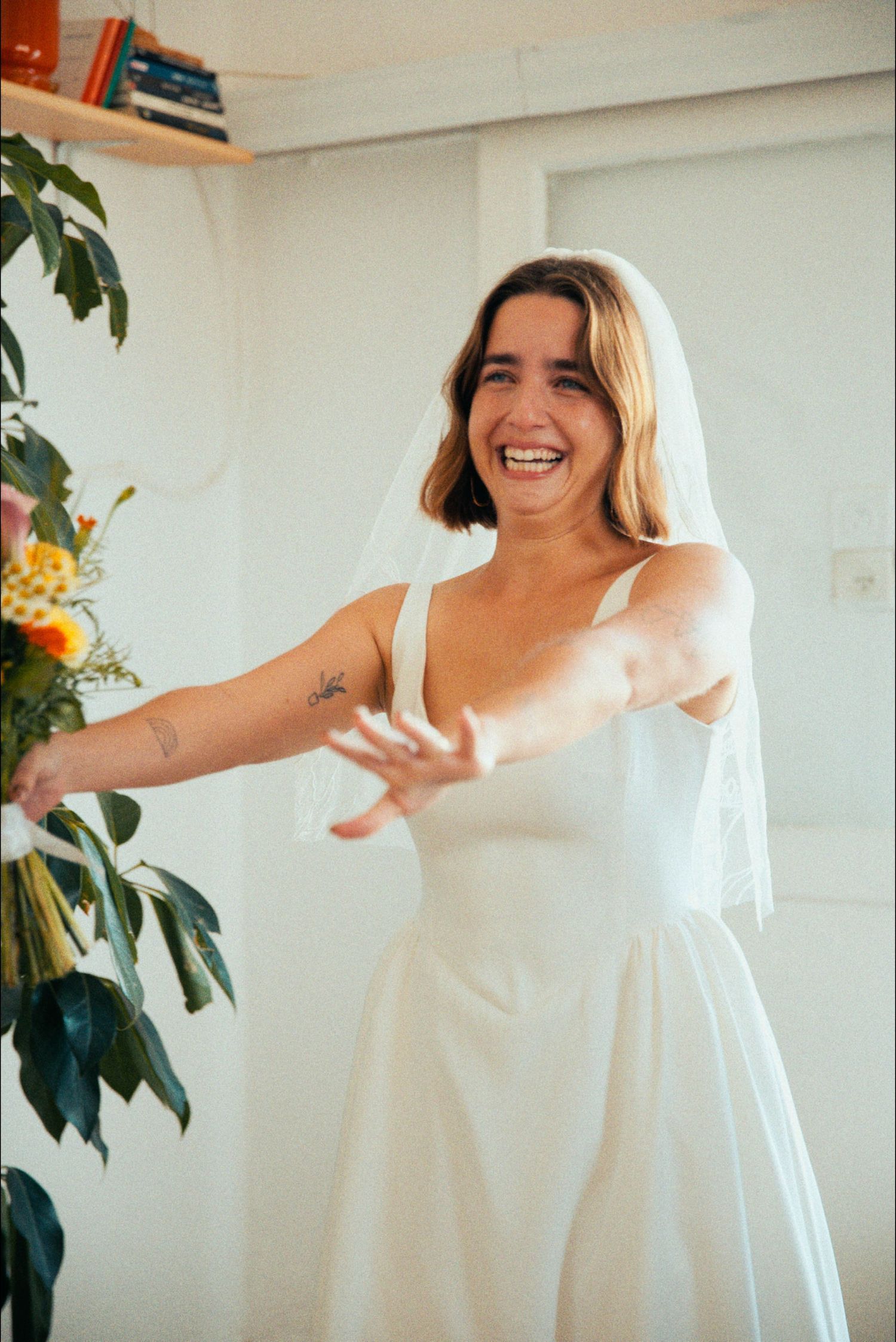 Dancing and twirling in a white dress with natural light streaming through windows.