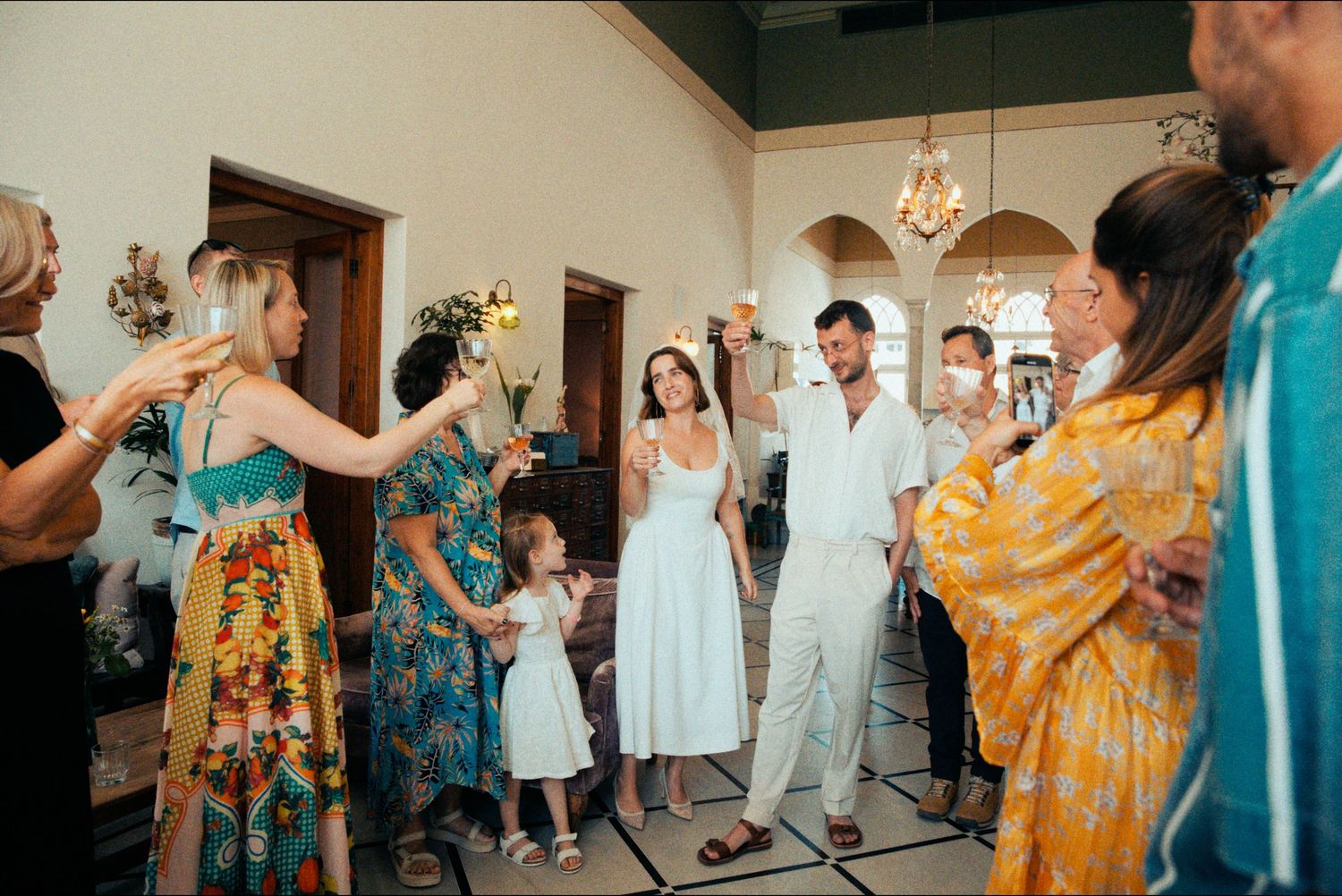 Wedding guests celebrate with the newlyweds during a festive reception.