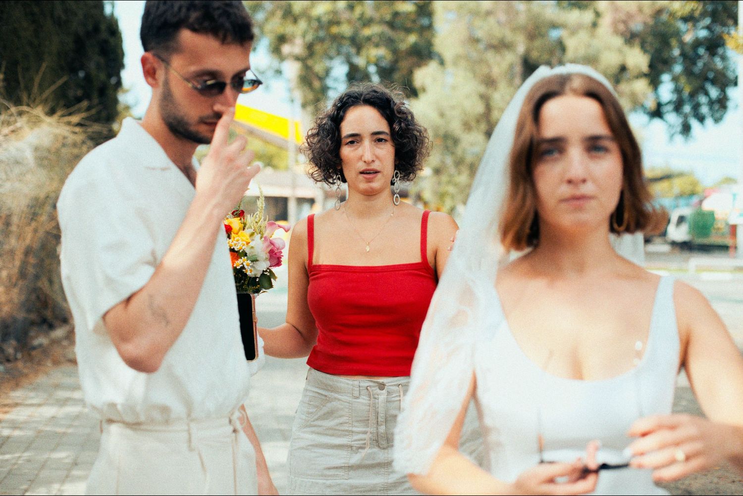 A collection of candid wedding portraits with pops of red against neutral backgrounds.