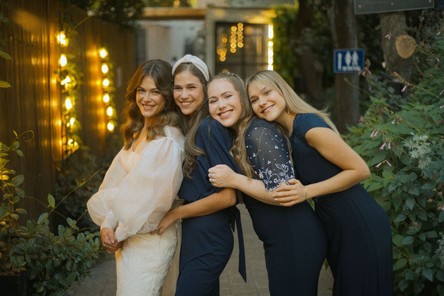 Candid moments of celebration captured at an outdoor evening wedding reception.