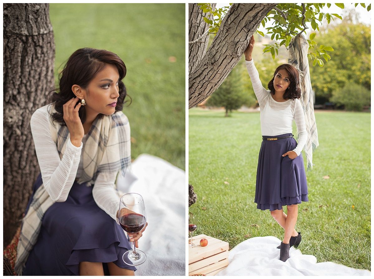Casual outdoor photoshoot in park setting with navy dress and white cardigan.