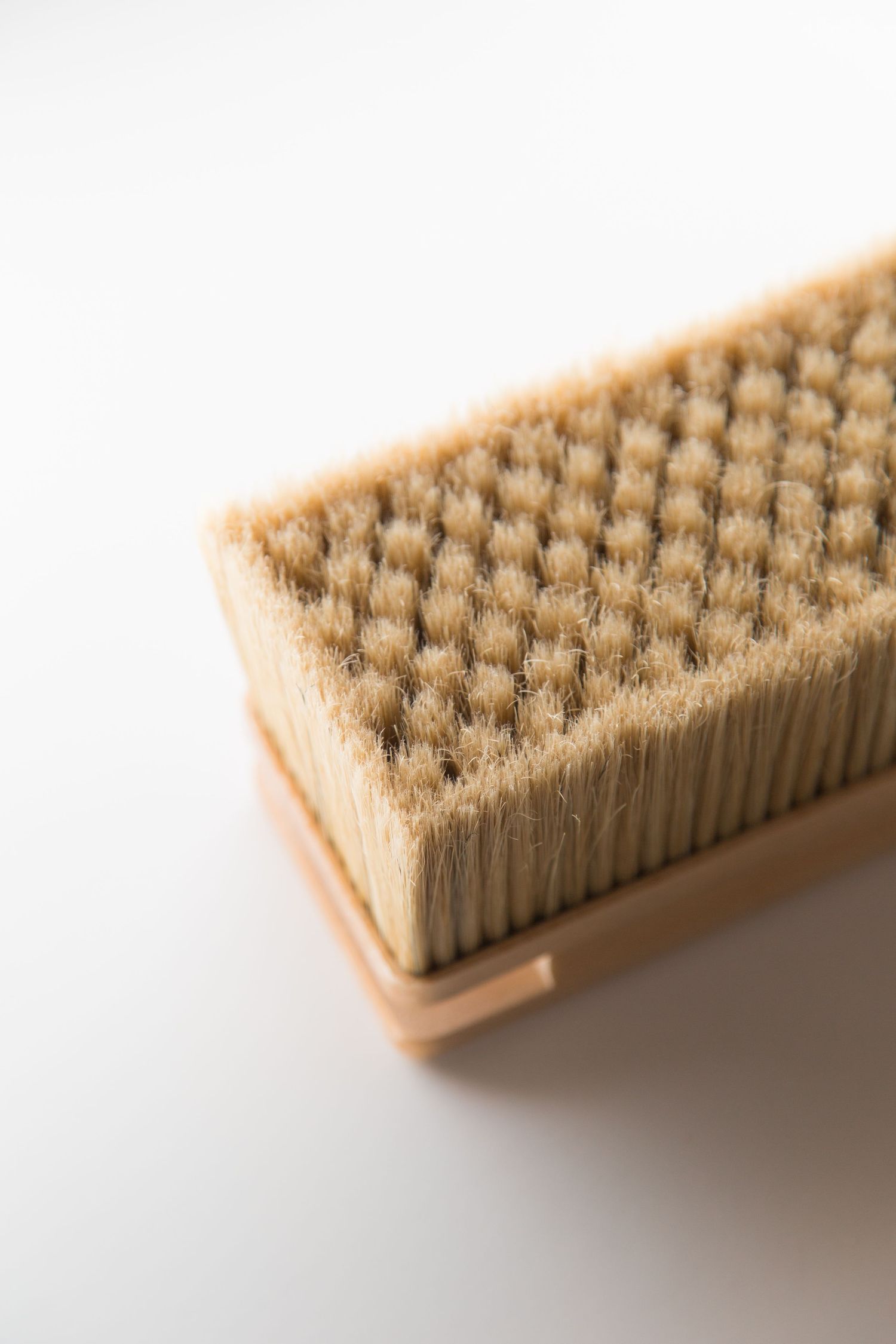 Detailed macro shot of brush bristles showing textured pattern against white background.