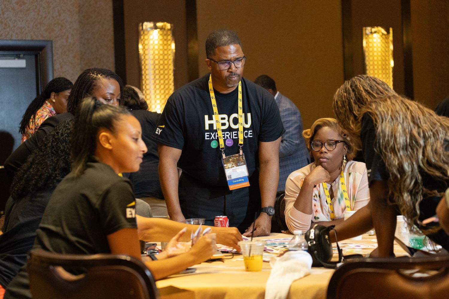 People gathered around a table during a workshop or meeting discussion.
