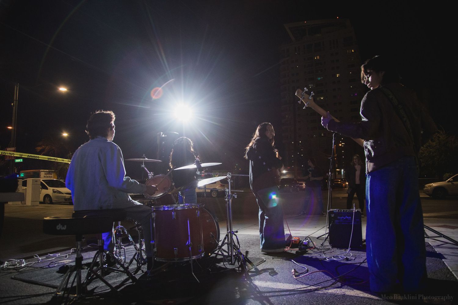 Concert stage setup with lighting equipment in dark outdoor venue.