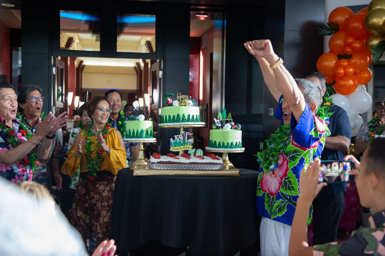 Party scene with green golf-themed cakes and celebratory atmosphere.